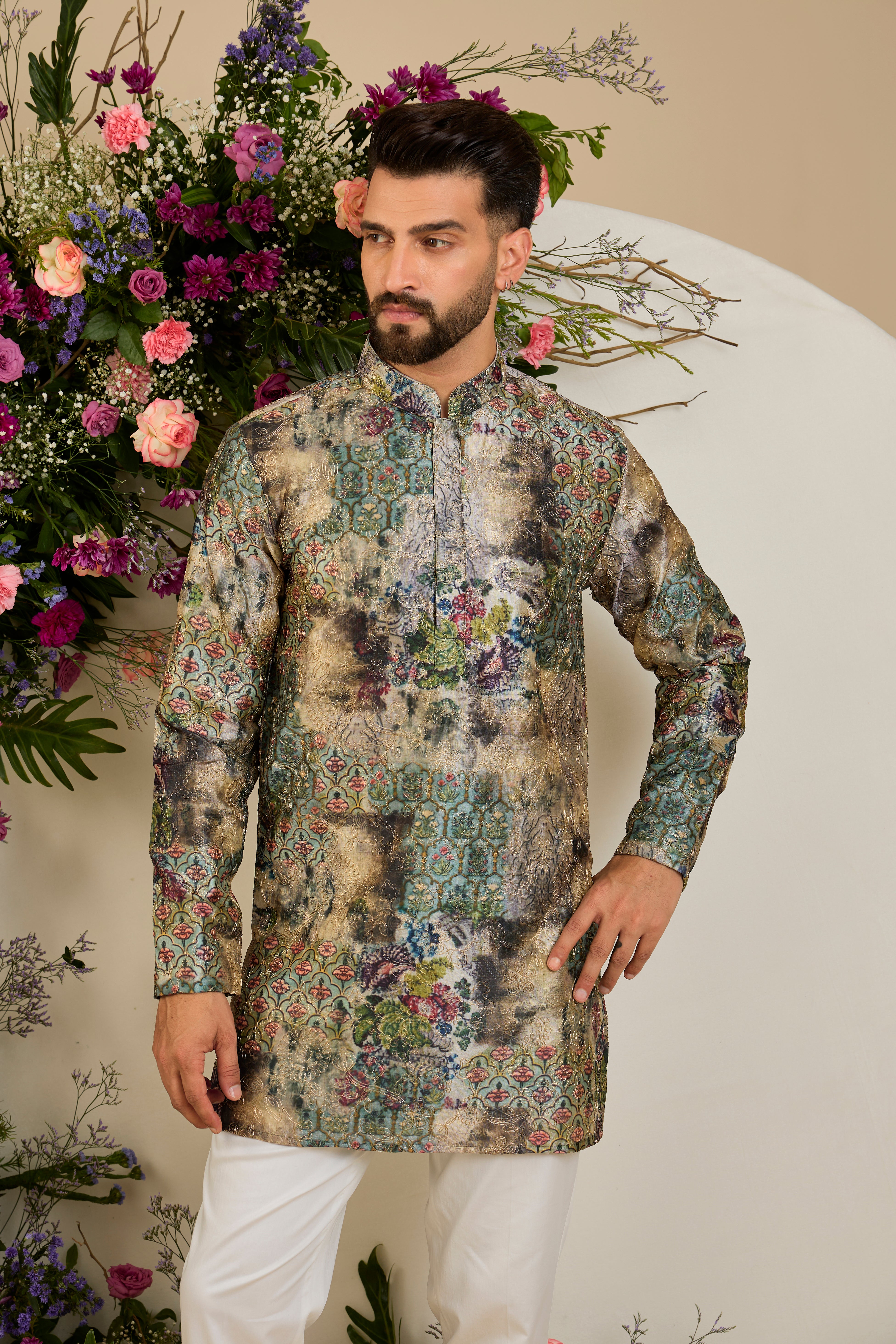 Showcasing a vibrant multi-coloured floral backdrop, this short kurta is elevated with refined aari craftsmanship .An exceptional expression of contemporary couture and timeless elegance.