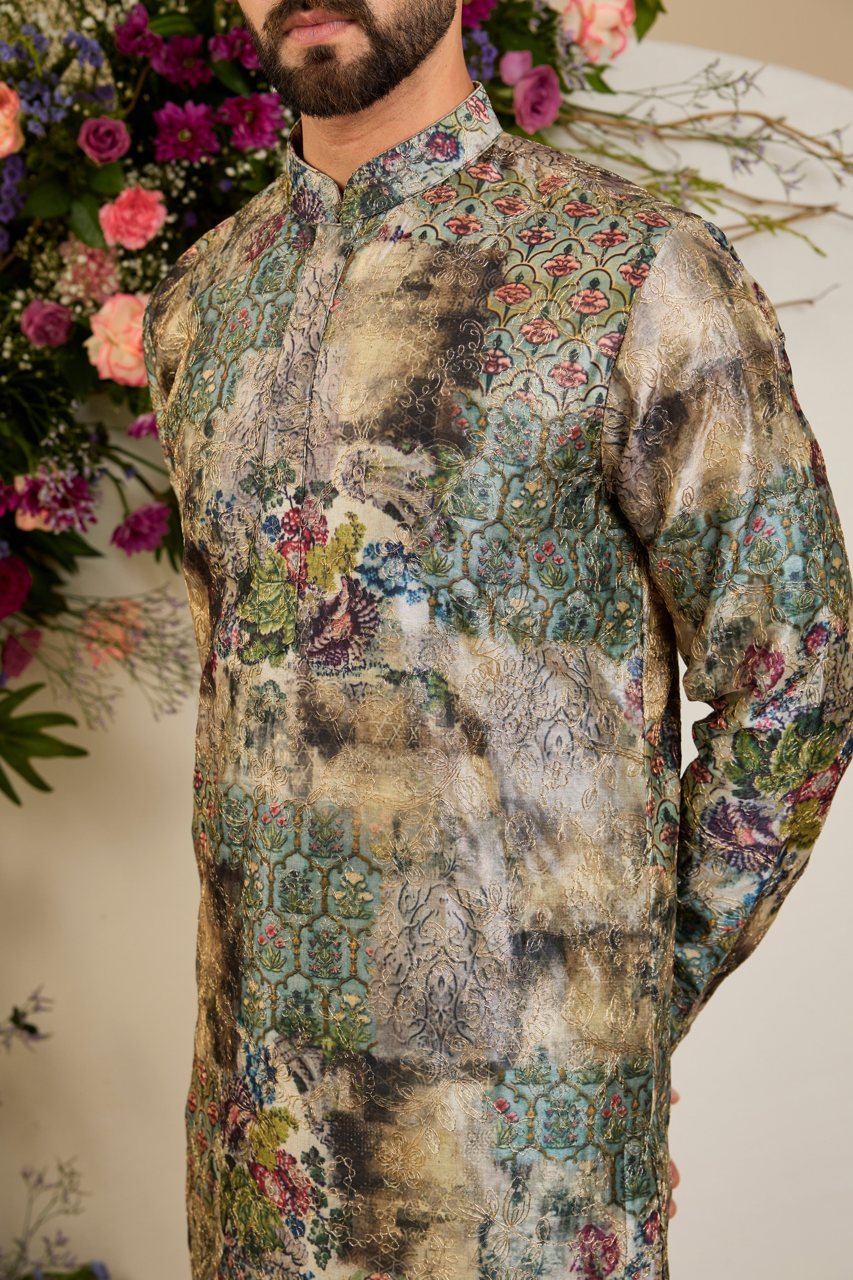 Showcasing a vibrant multi-coloured floral backdrop, this short kurta is elevated with refined aari craftsmanship .An exceptional expression of contemporary couture and timeless elegance.