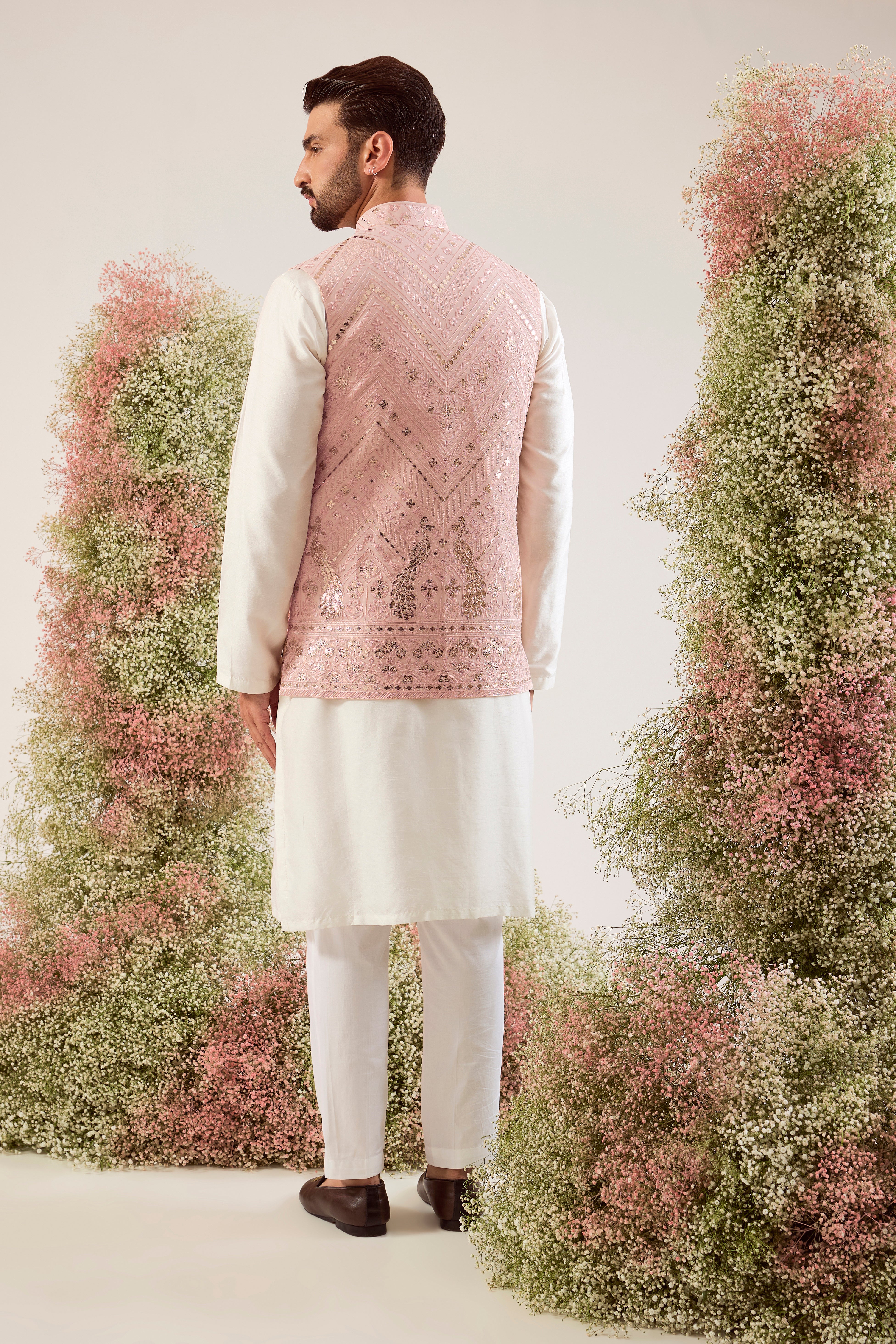 peach leather patchwork jacket with intricate peacock motifs