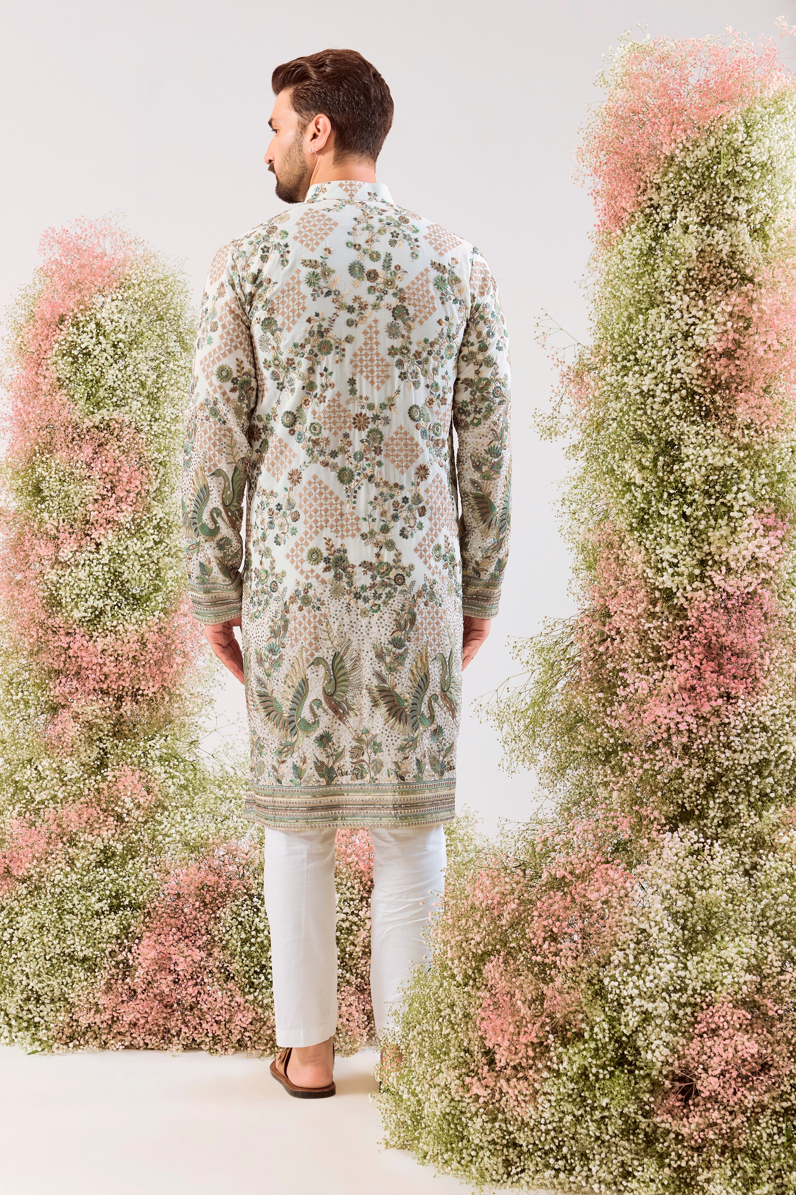 white sequined kurta with intricate flora and fauna embroidery