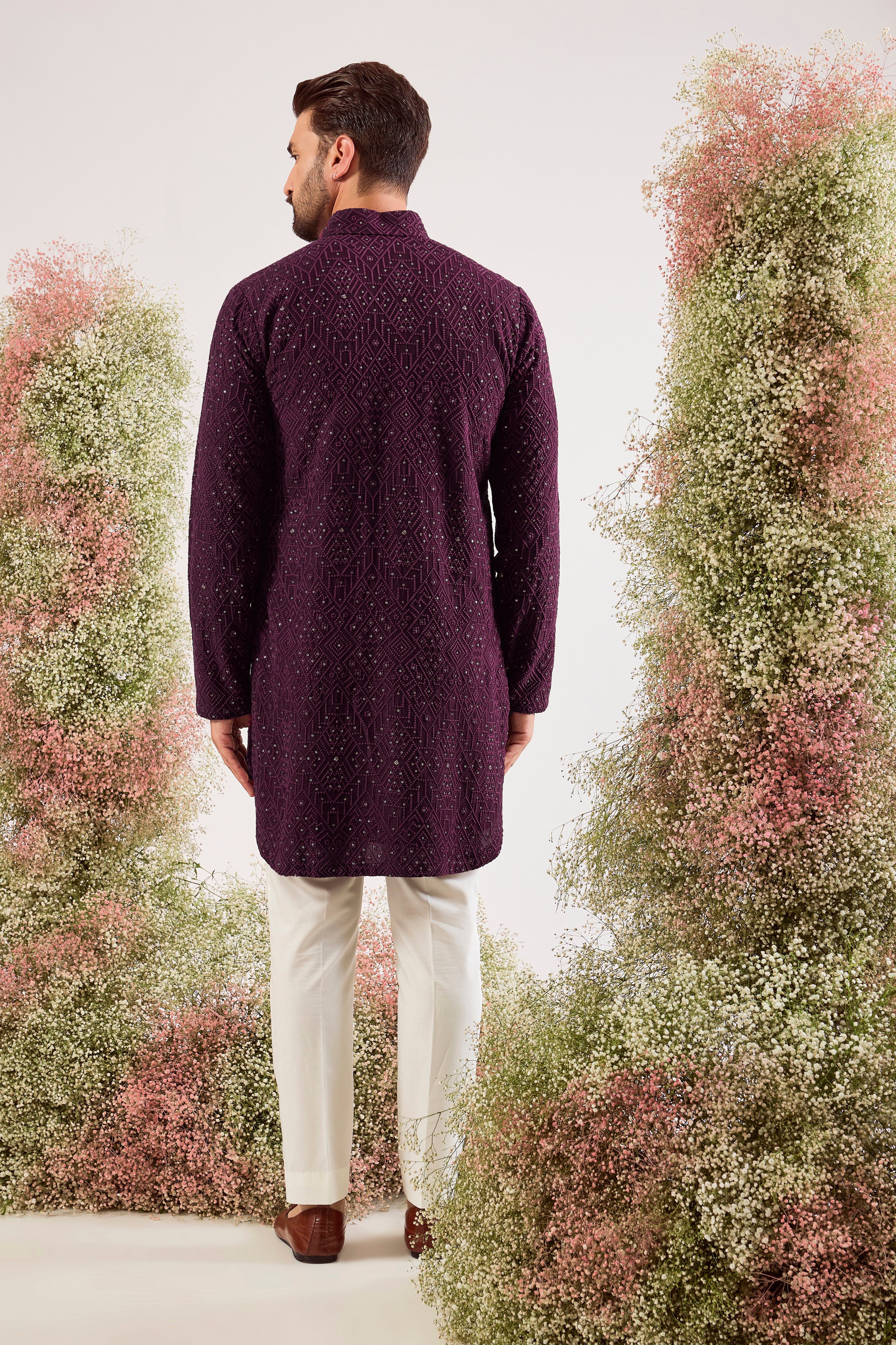 This elegant wine geometrically embroidered short pathani kurta is a masterpiece of modern design.