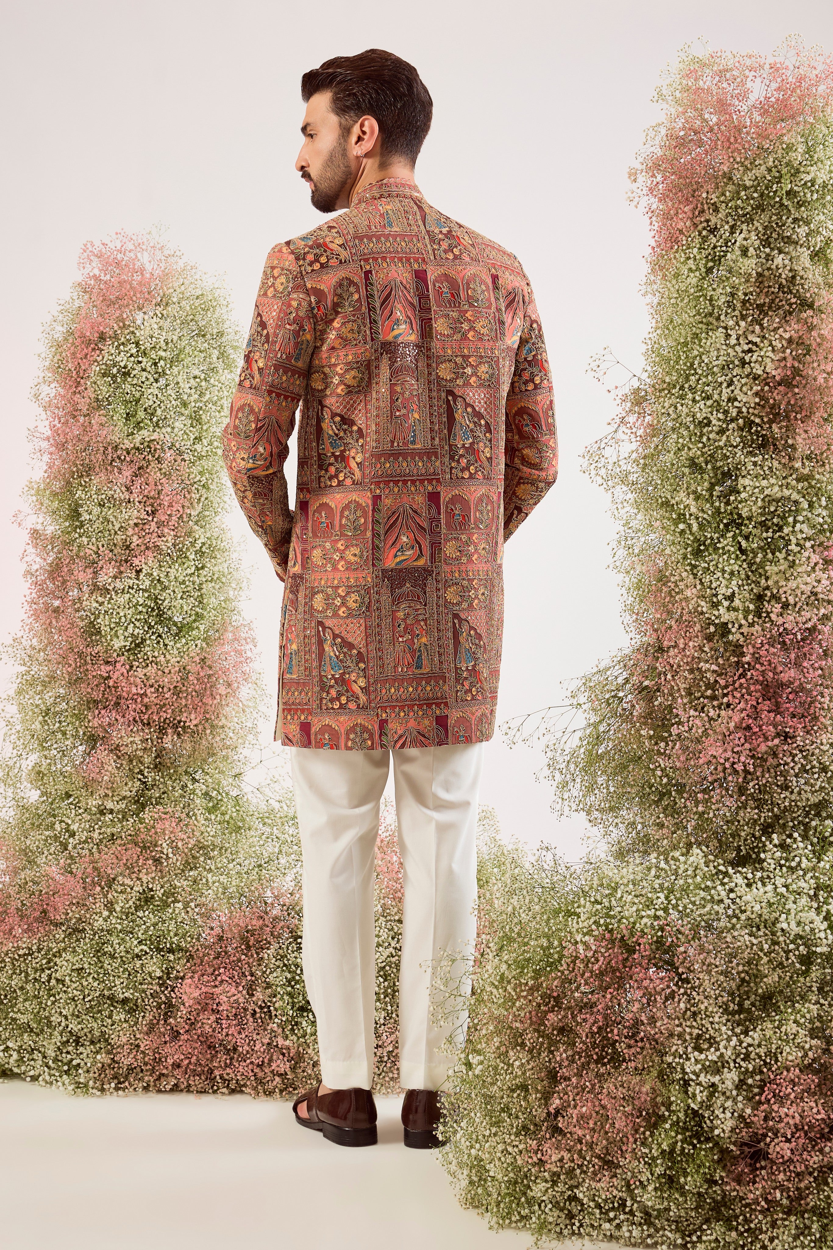 This magnificent mauve royal heritage short sherwani is a true masterpiece of traditional artistry and modern elegance