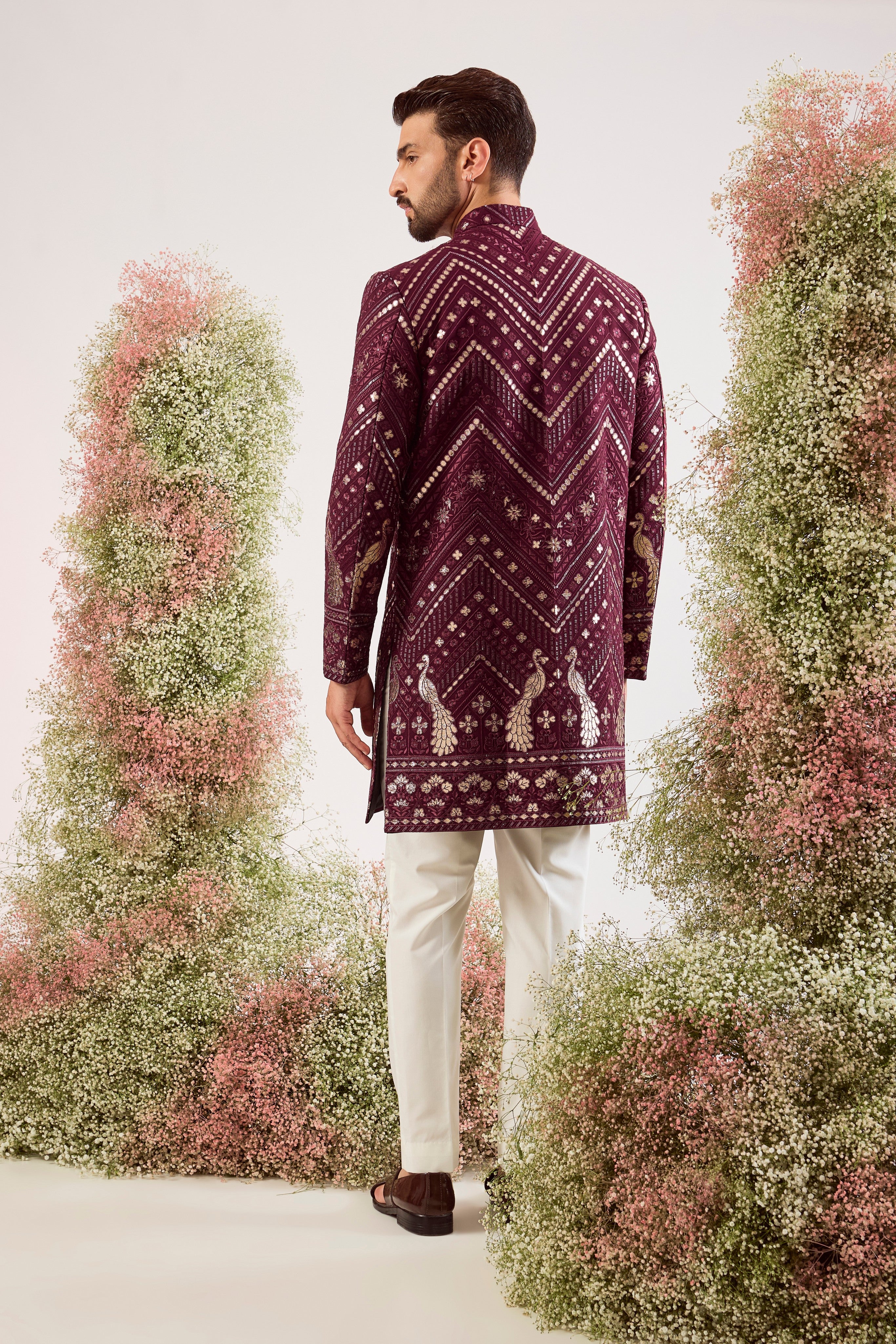 This majestic magenta short Indo-western is a true work of art, designed for the man who dares to be different.