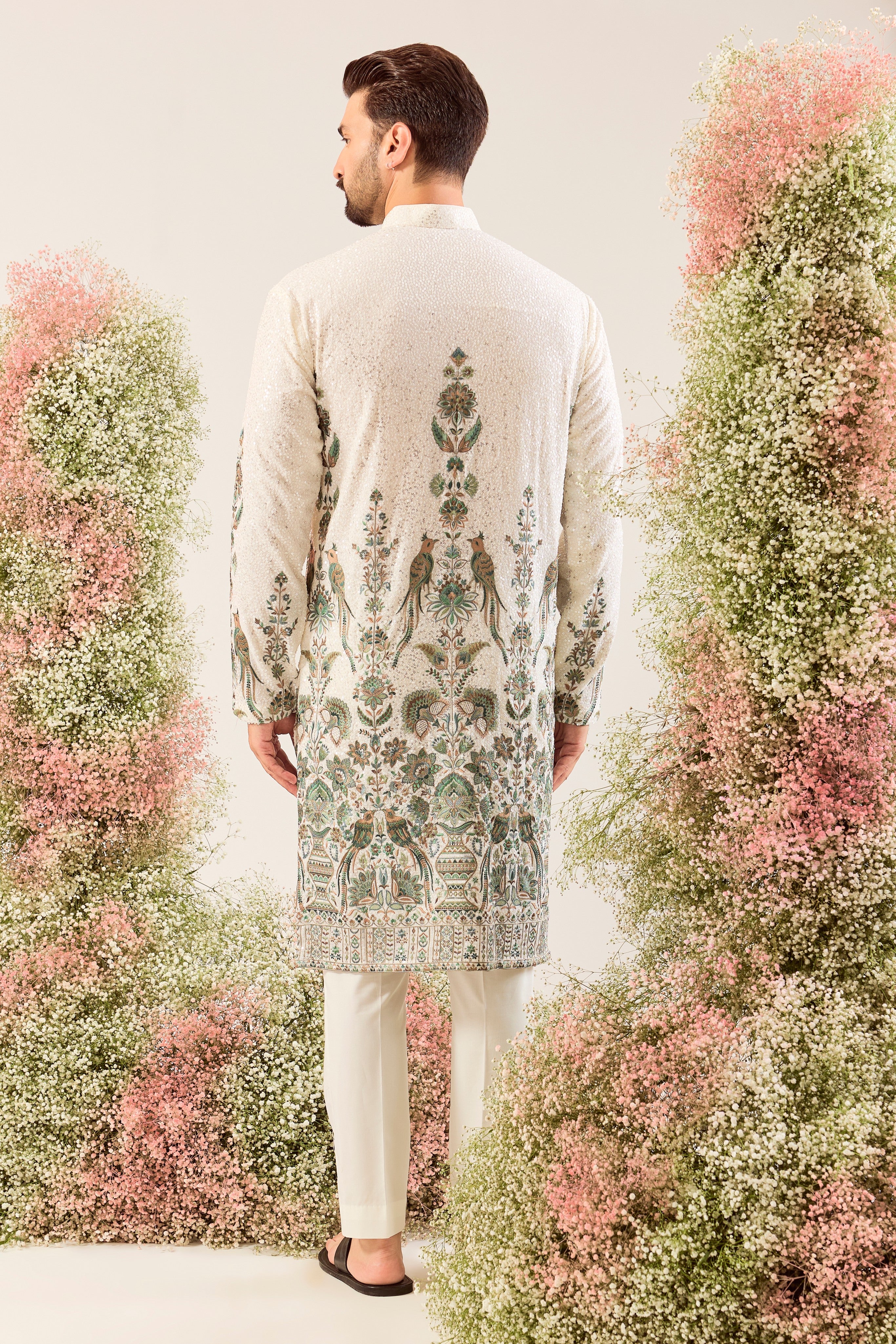 This exquisite white sequined kurta is a true masterpiece of refined artistry.