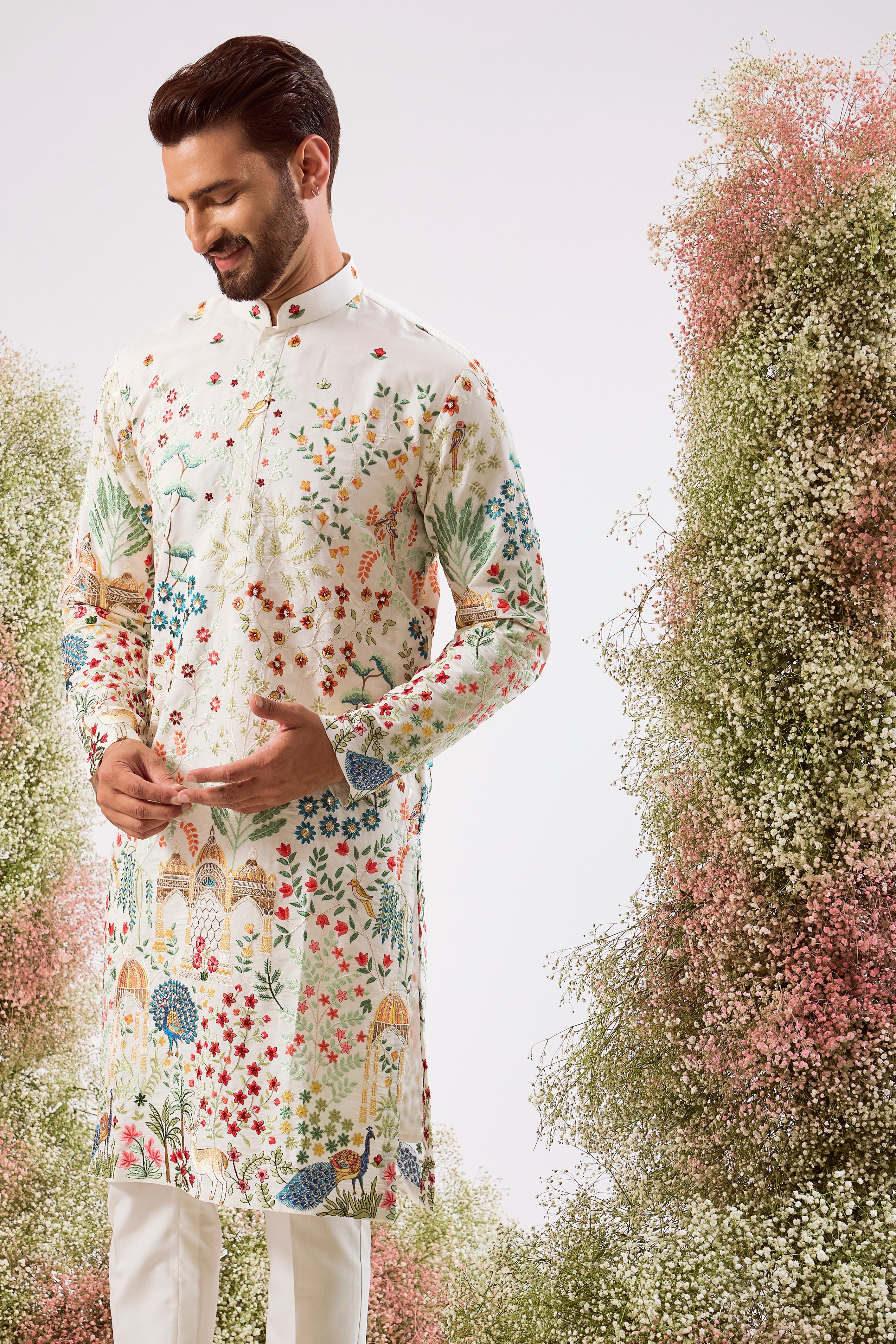 white royal heritage chikankari kurta with intricate interplay of flora and fauna and detailed mughar darbar figures