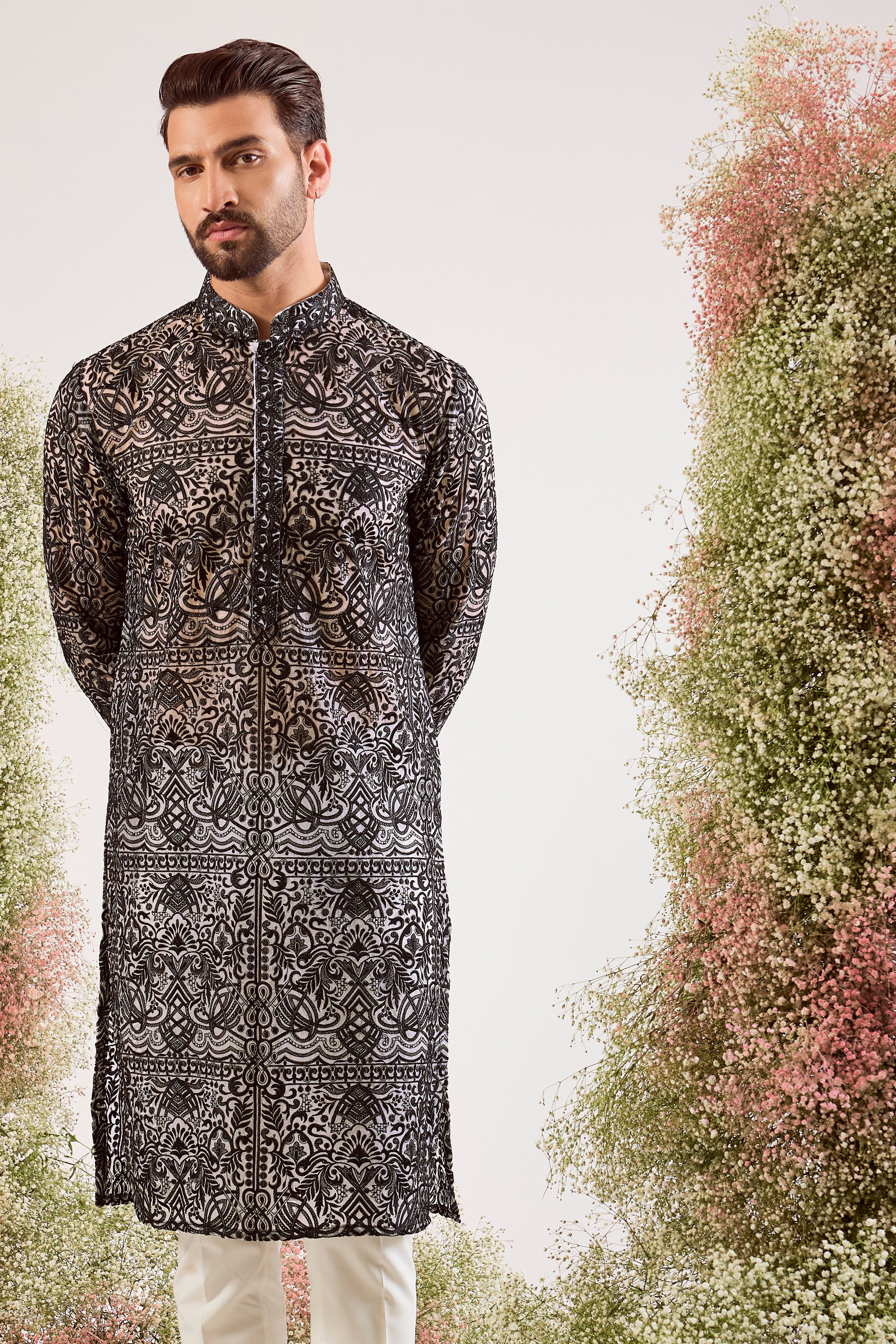 This striking black chikankari long see-through kurta is a masterpiece of modern elegance.