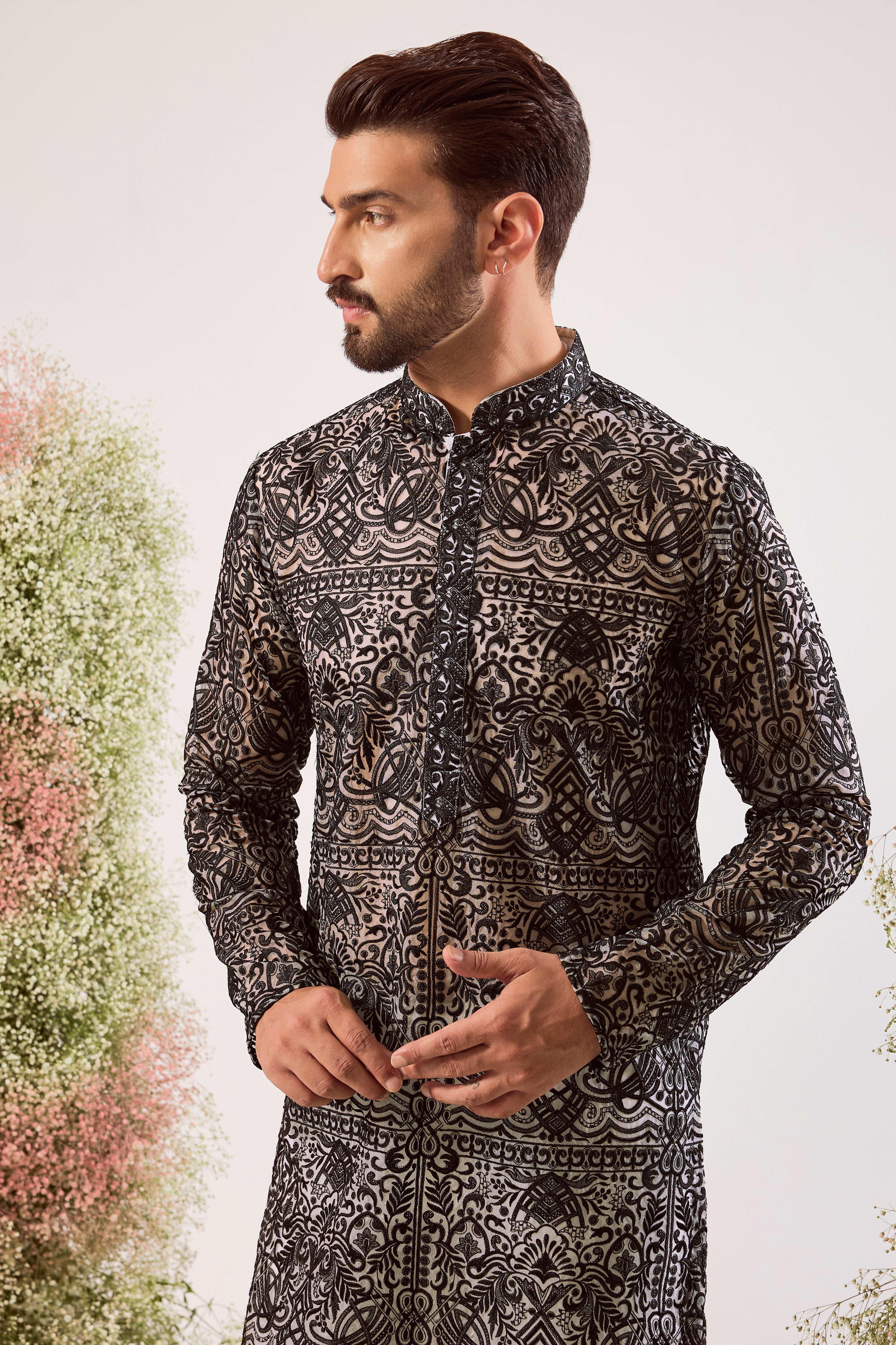 This striking black chikankari long see-through kurta is a masterpiece of modern elegance.