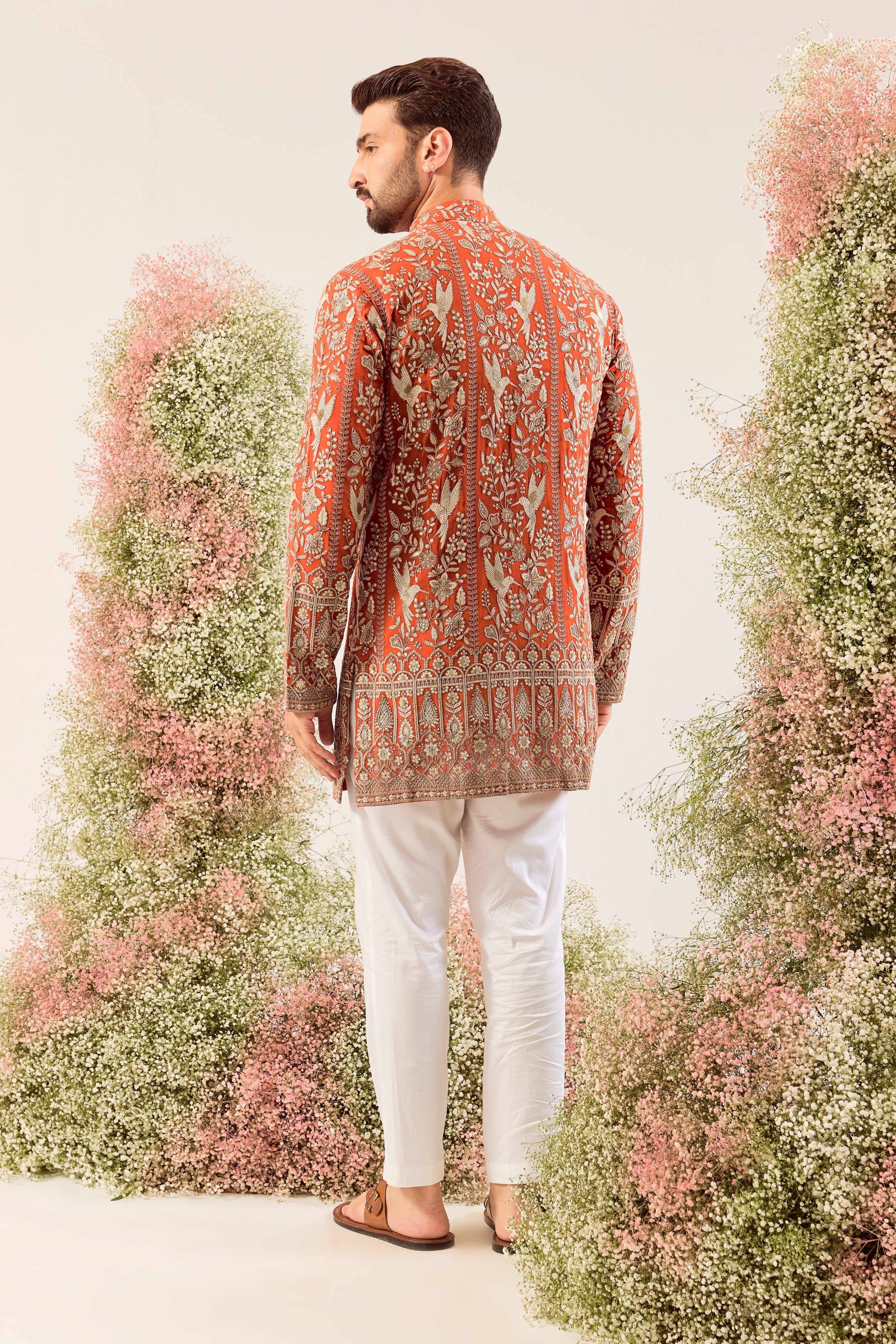 This elegant orange short chikankari kurta is a masterpiece of modern artistry.