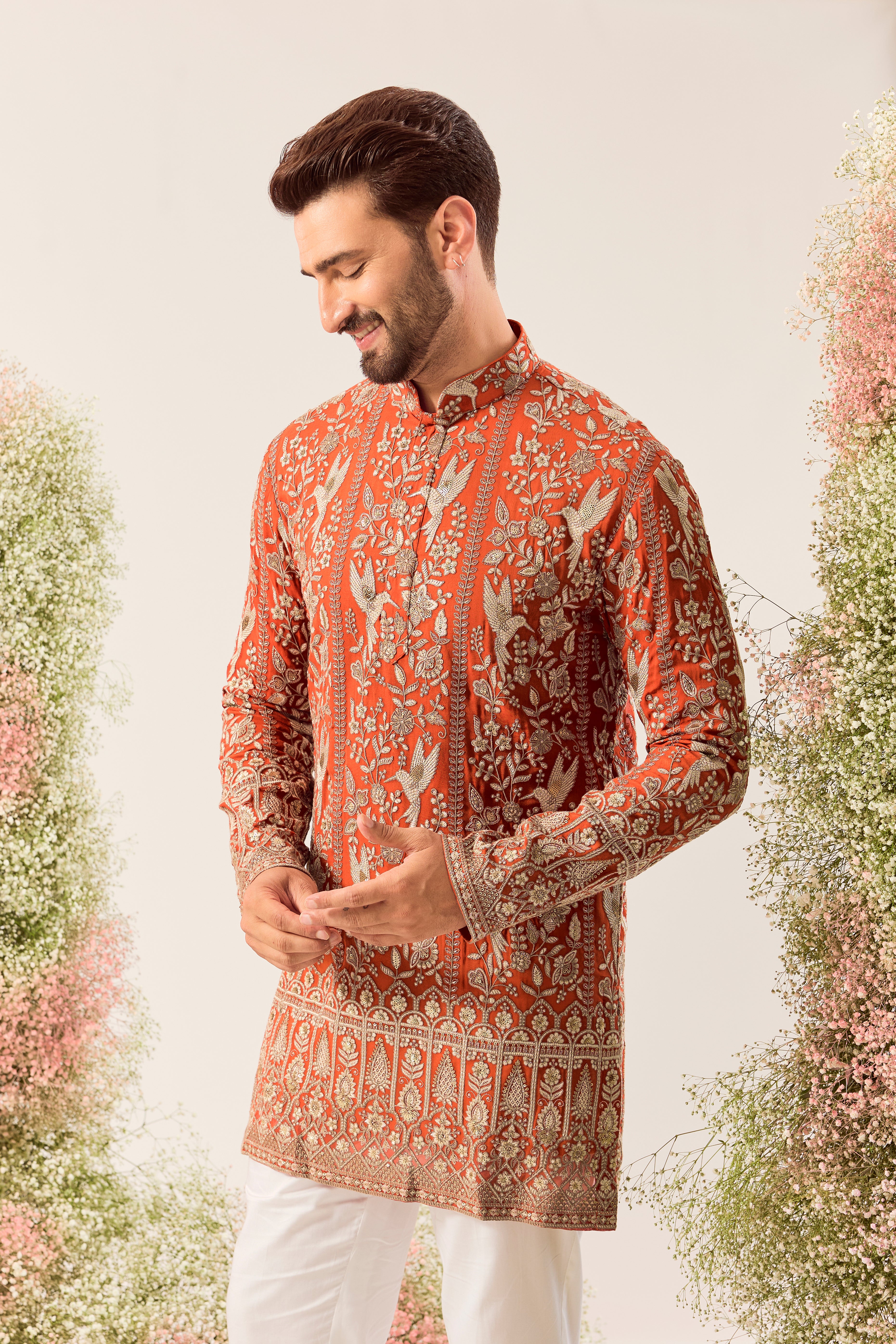 This elegant orange short chikankari kurta is a masterpiece of modern artistry.