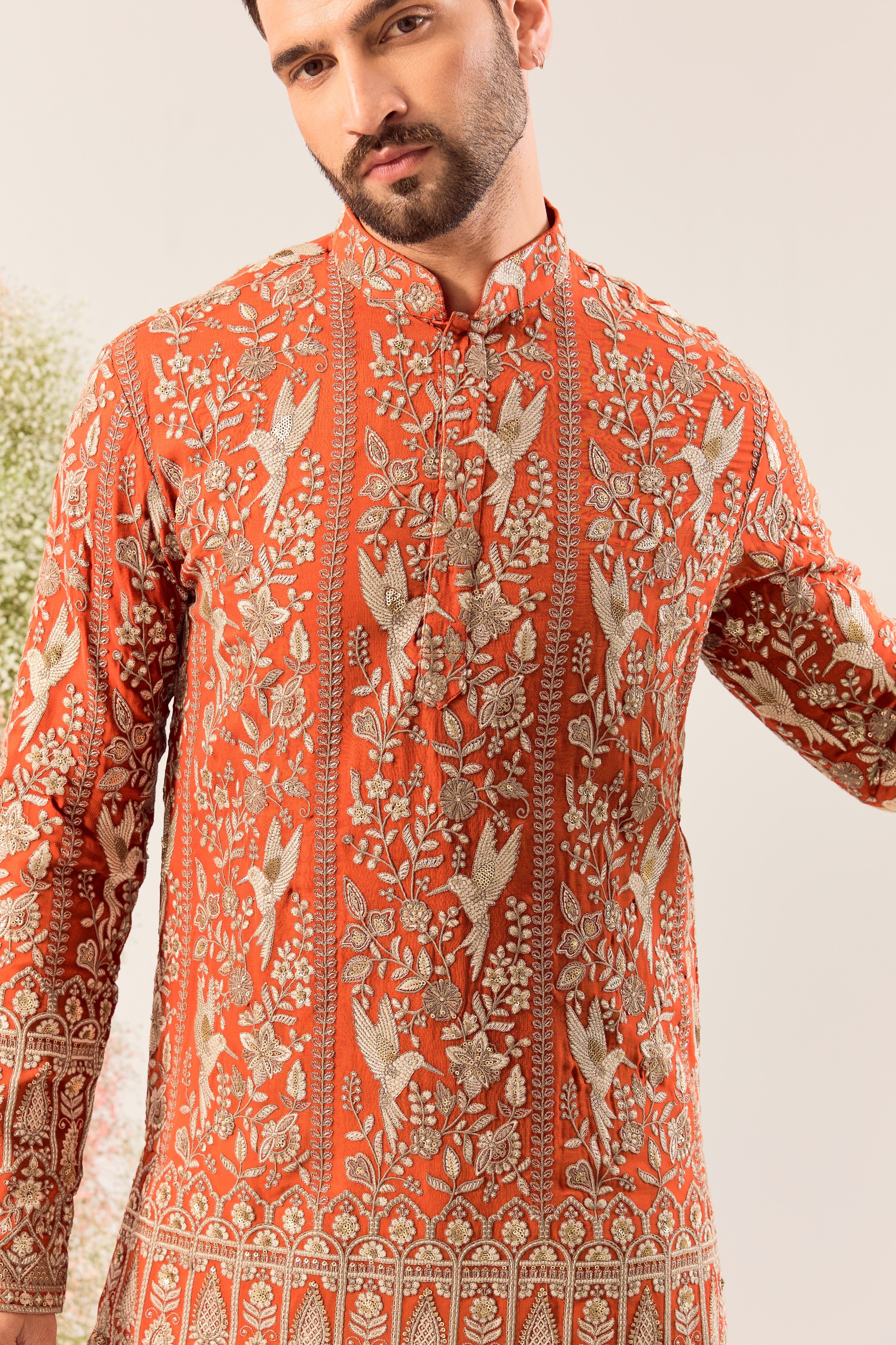 This elegant orange short chikankari kurta is a masterpiece of modern artistry.