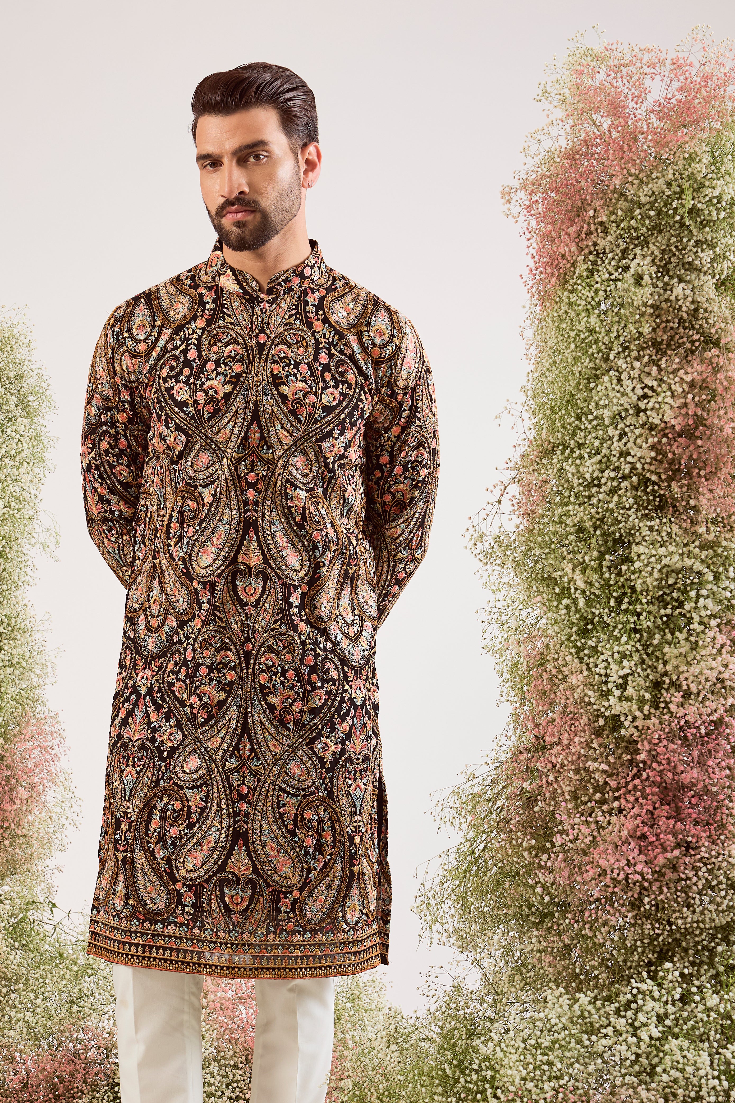 This striking black Kashmiri embroidered kurta is a masterpiece of traditional artistry.
