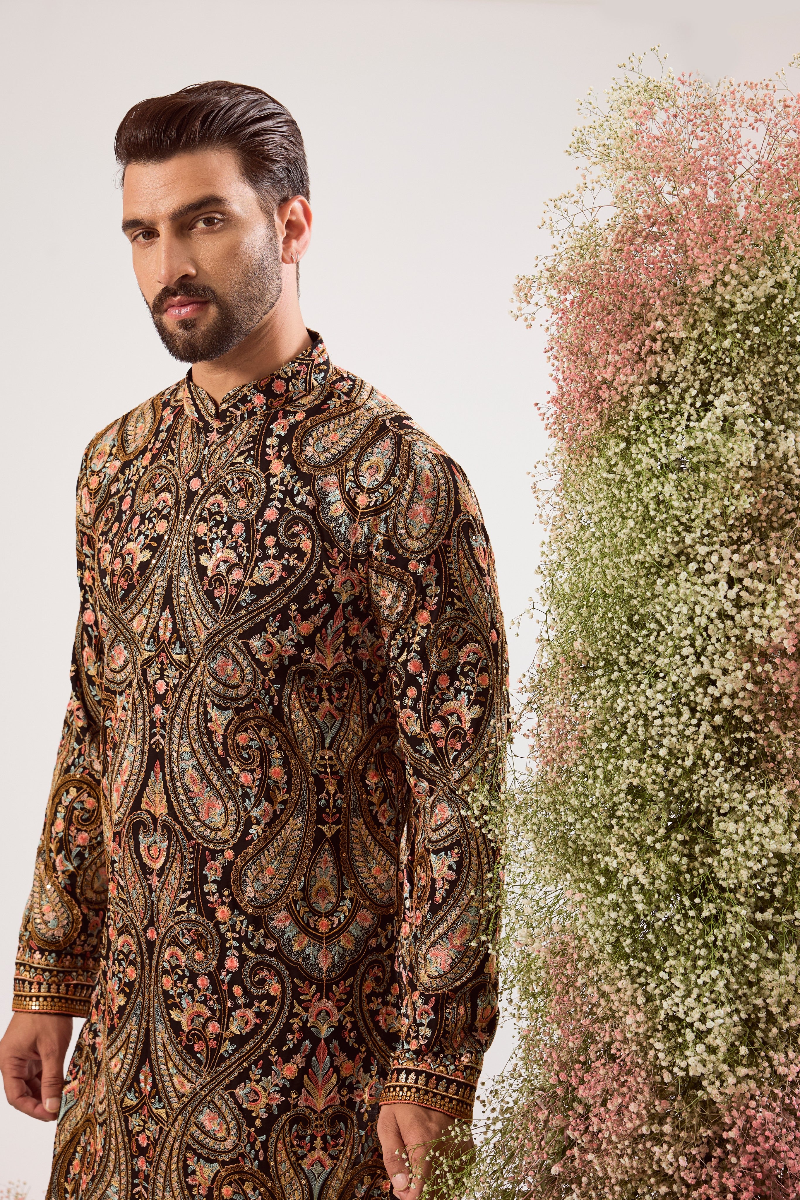 This striking black Kashmiri embroidered kurta is a masterpiece of traditional artistry.