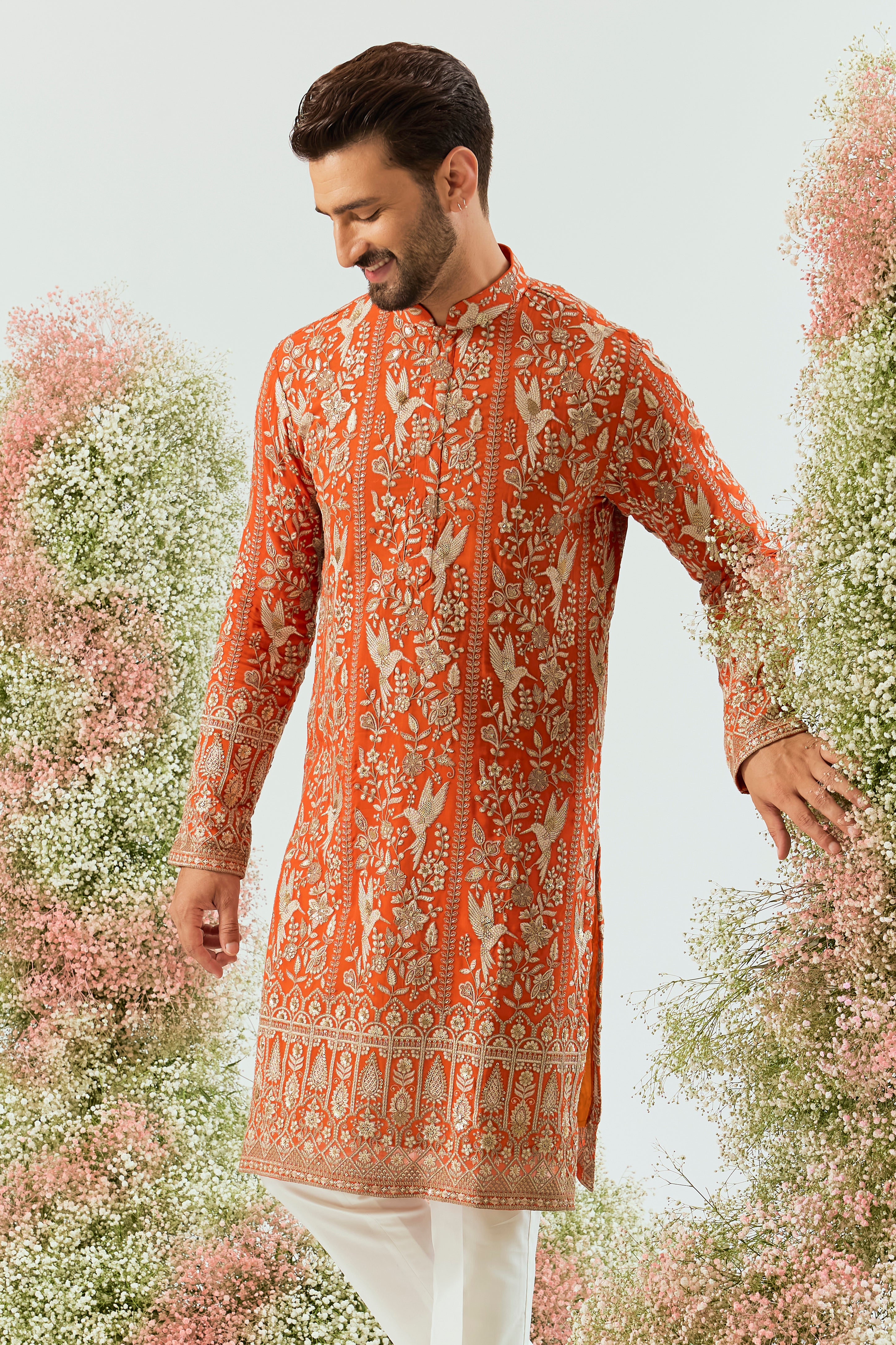 orange chikankari long kurta with intricate flora and fauna figures