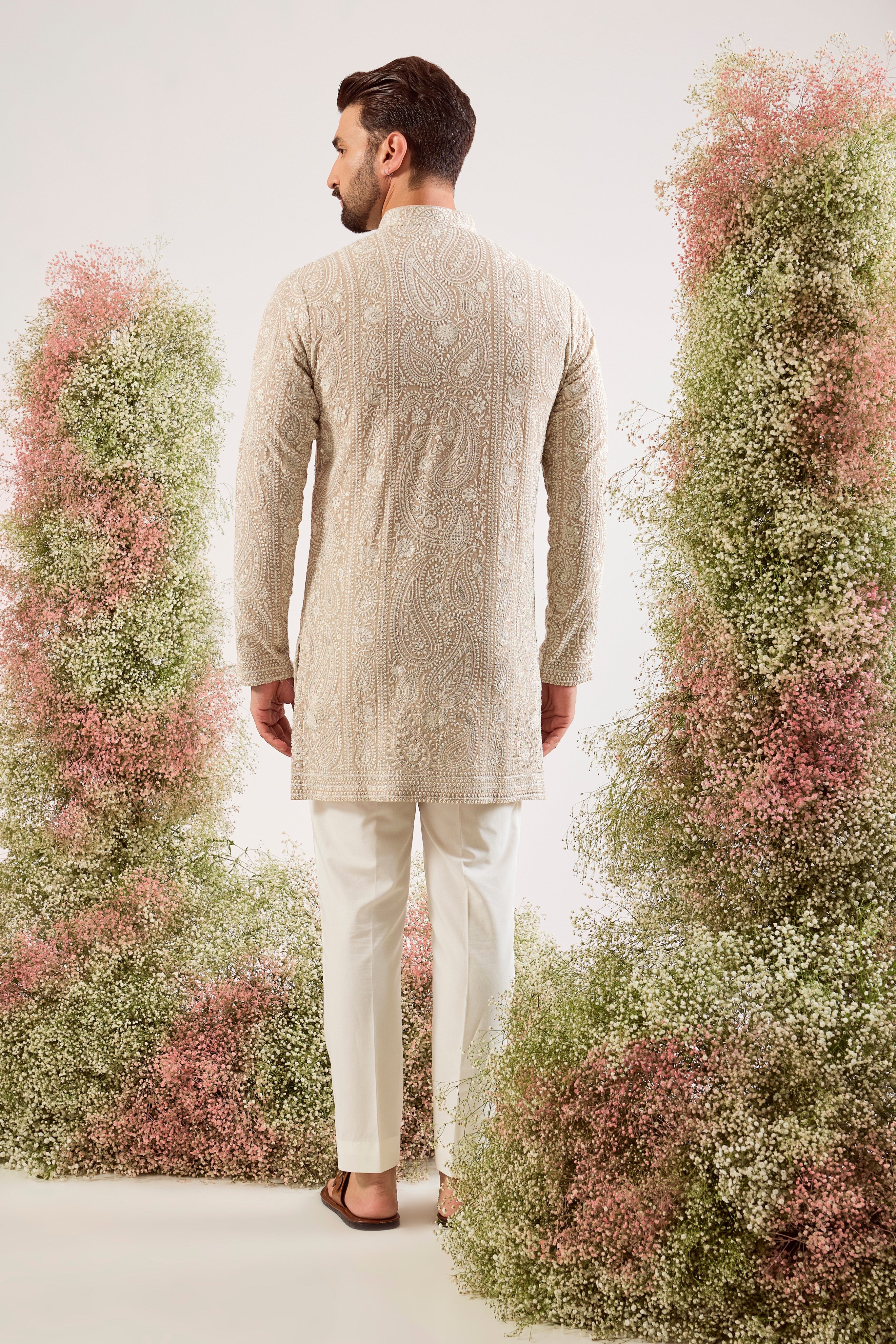 beige short chikankari kurta with delicate paisley figures and sequin work