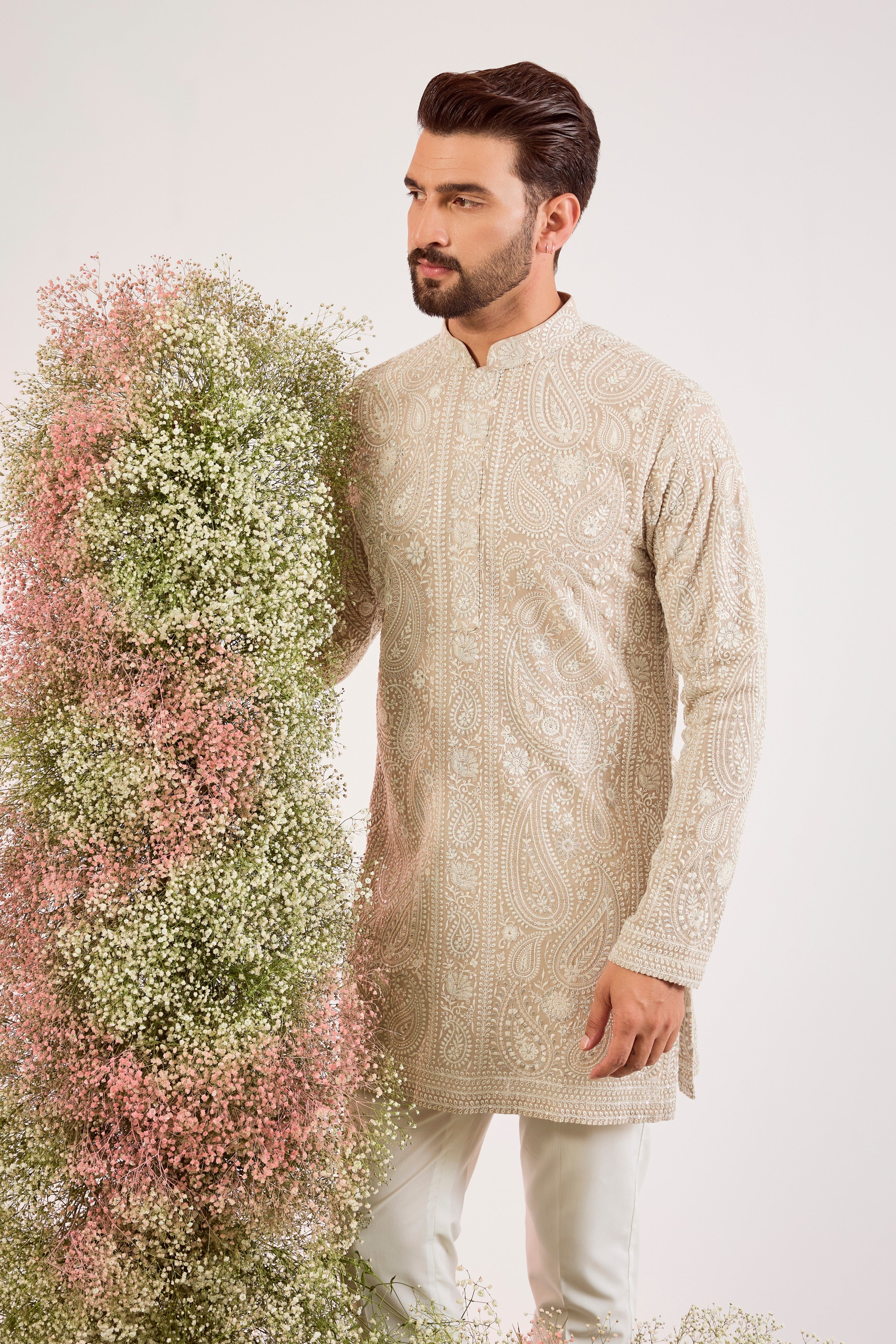 beige short chikankari kurta with delicate paisley figures and sequin work