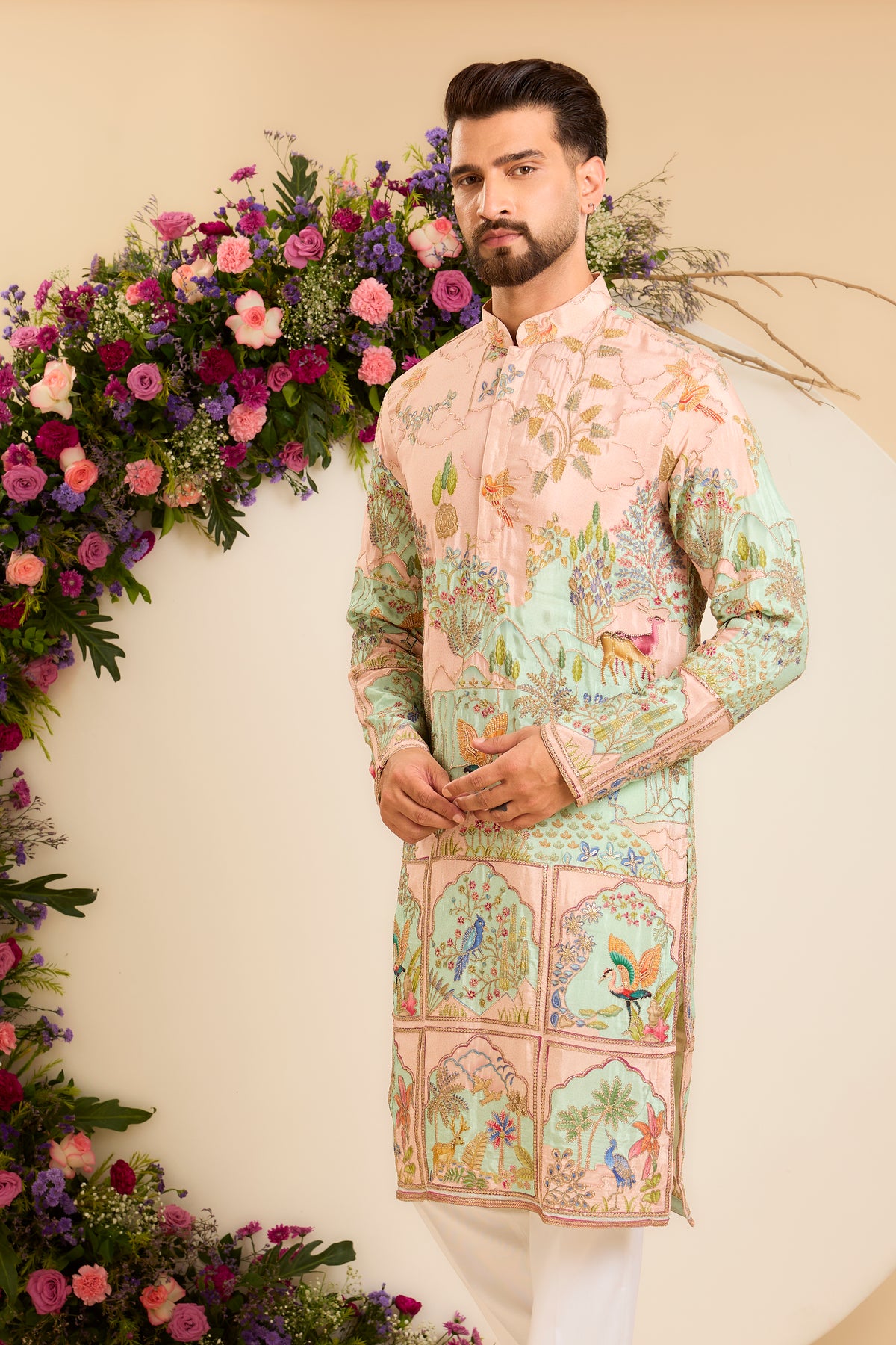 A Vibrant pink Crepe Kurta Richly Embroidered with Wildlife