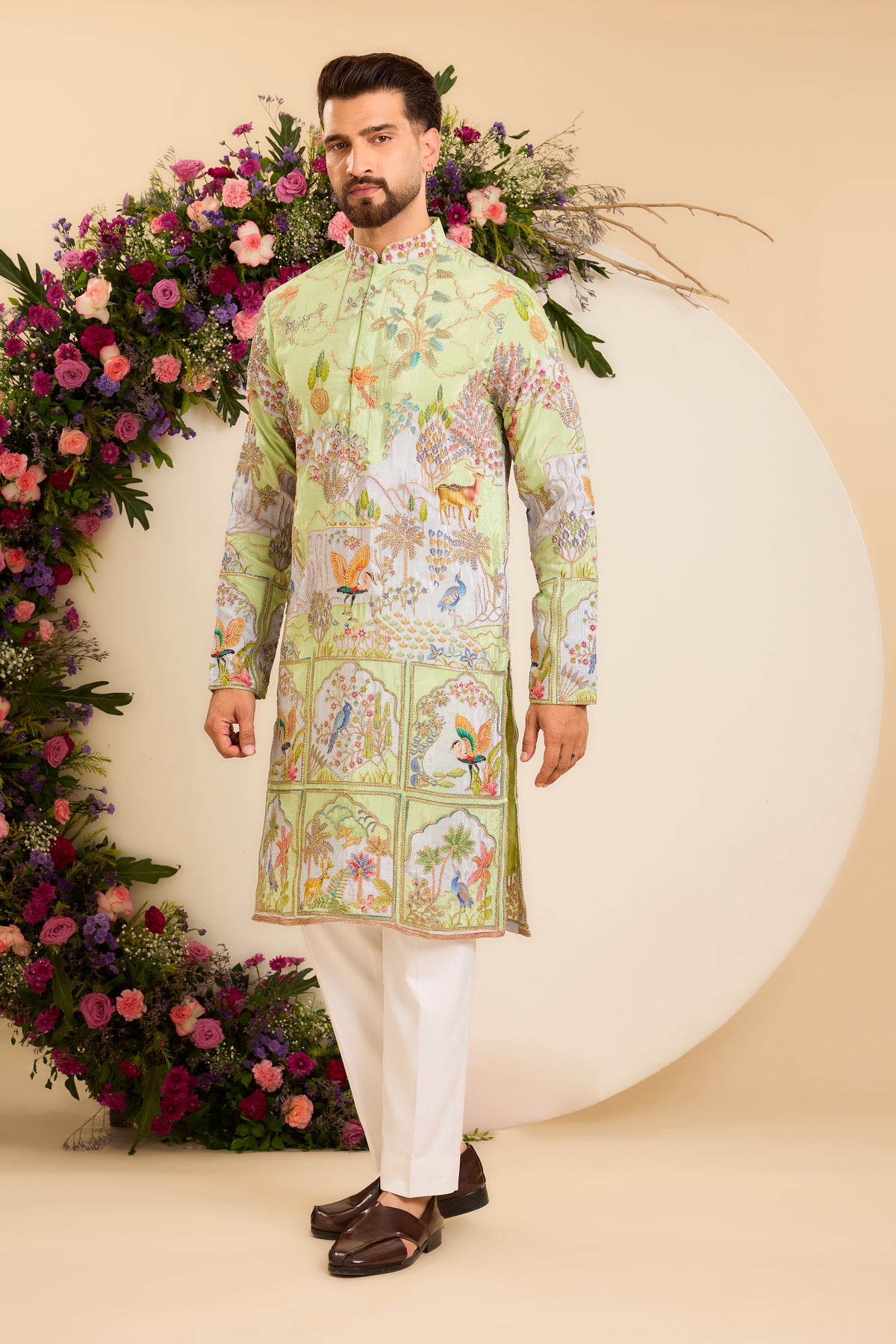 A Vibrant green Crepe Kurta Richly Embroidered with Wildlife