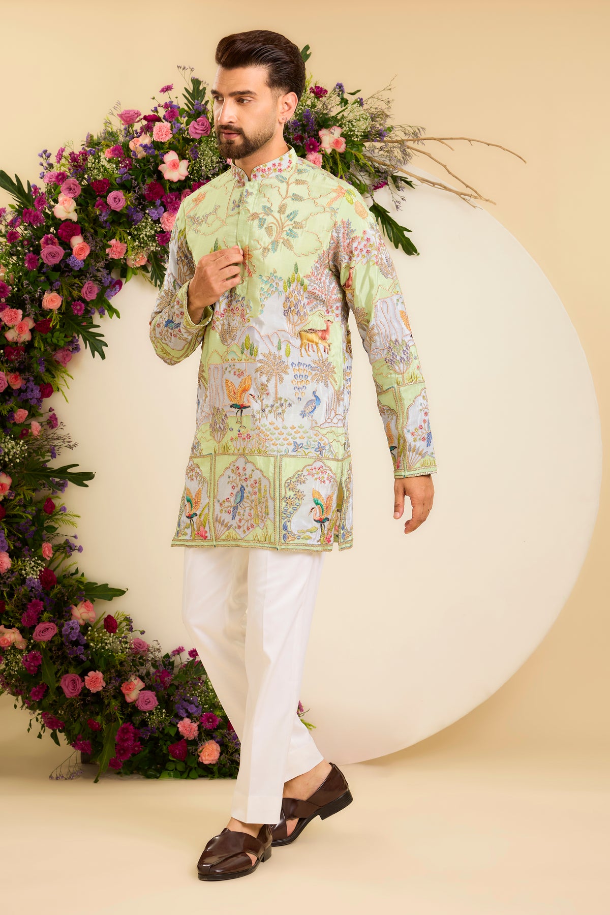 A Vibrant green Crepe short Kurta Richly Embroidered with Wildlife