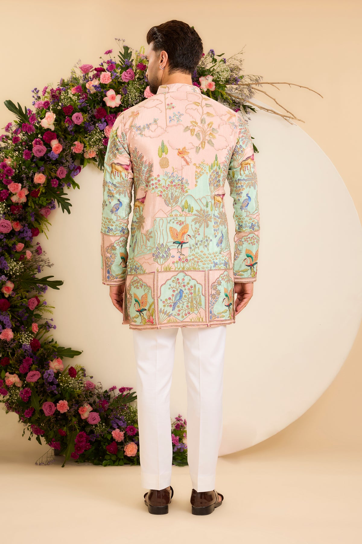 A Vibrant green Crepe short Kurta Richly Embroidered with Wildlife