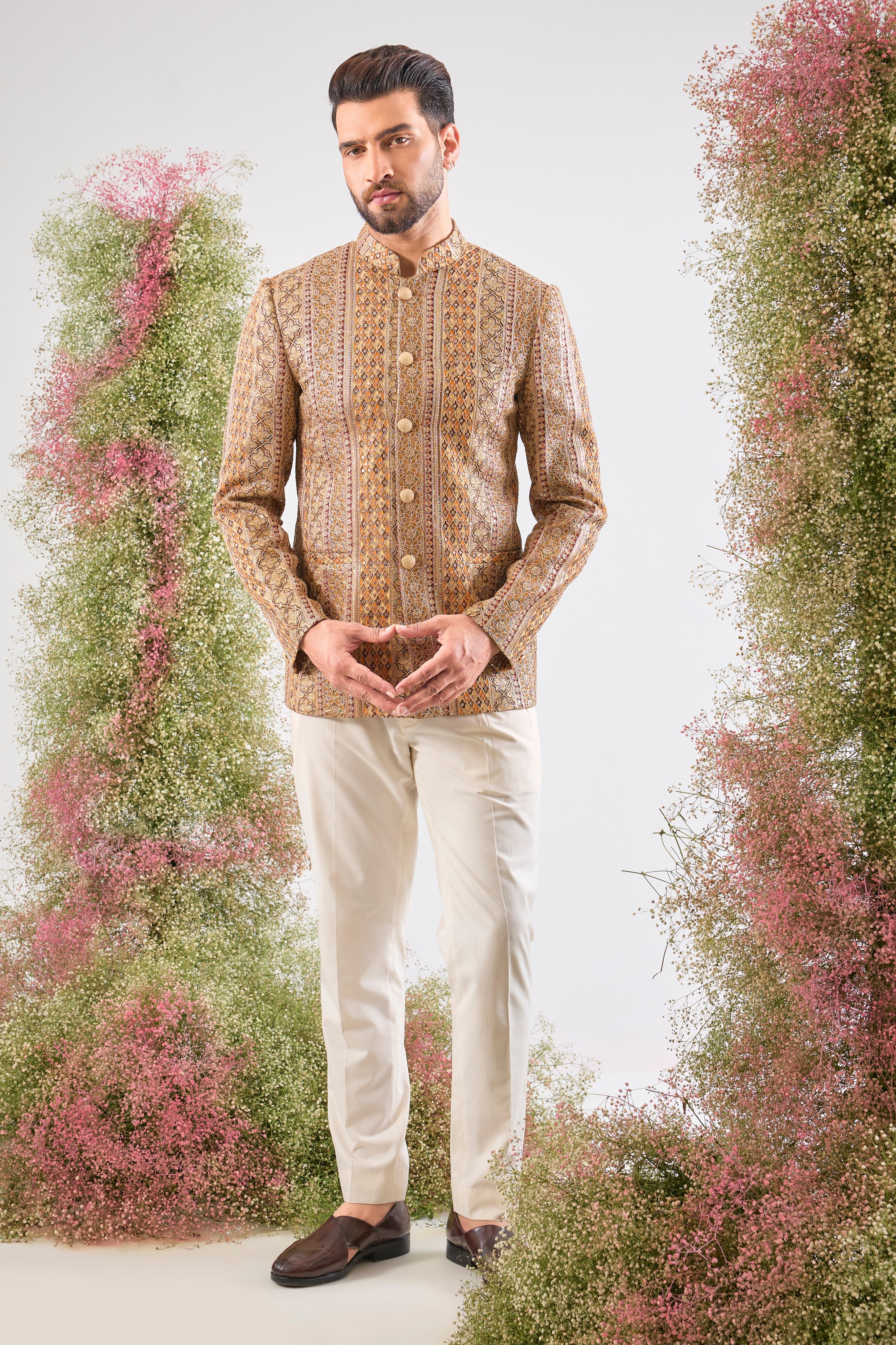 Artistry in vivid hues. This Mustard Bandhgala showcases opulent Heavy Zari Work and sequin accents, brilliantly integrating Shades of Green and Orange into the design.