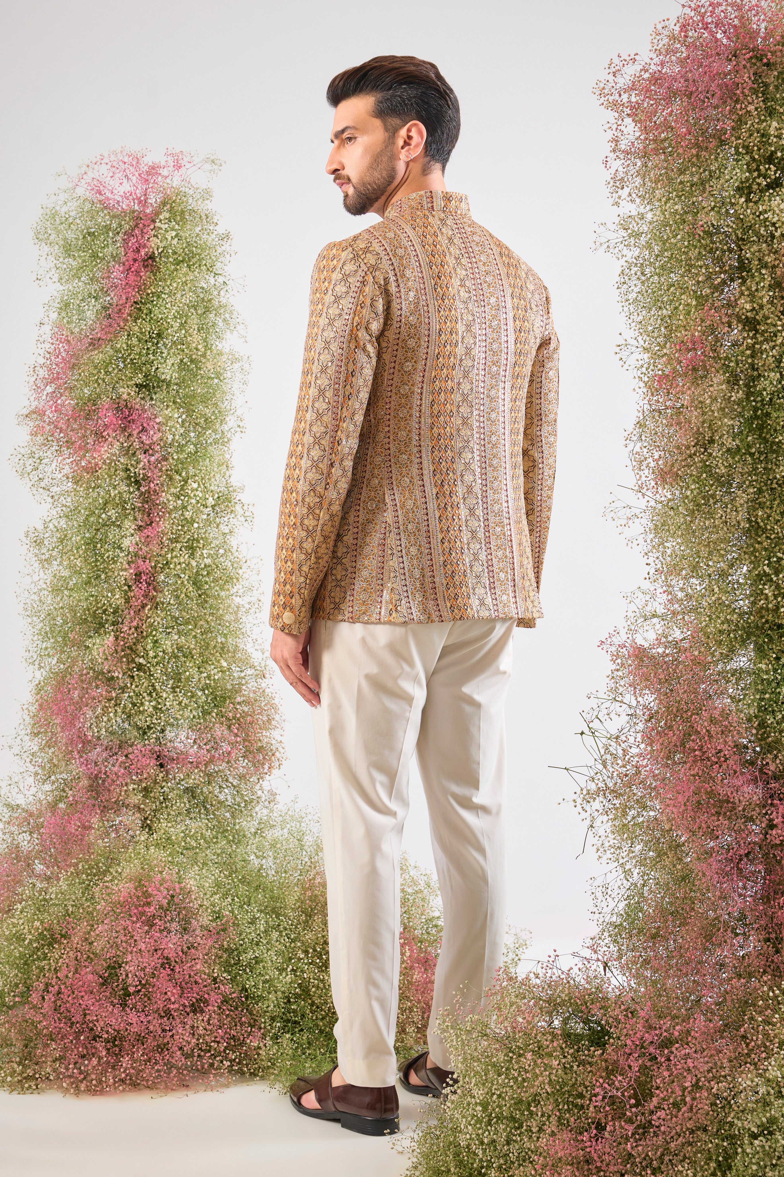 Artistry in vivid hues. This Mustard Bandhgala showcases opulent Heavy Zari Work and sequin accents, brilliantly integrating Shades of Green and Orange into the design.