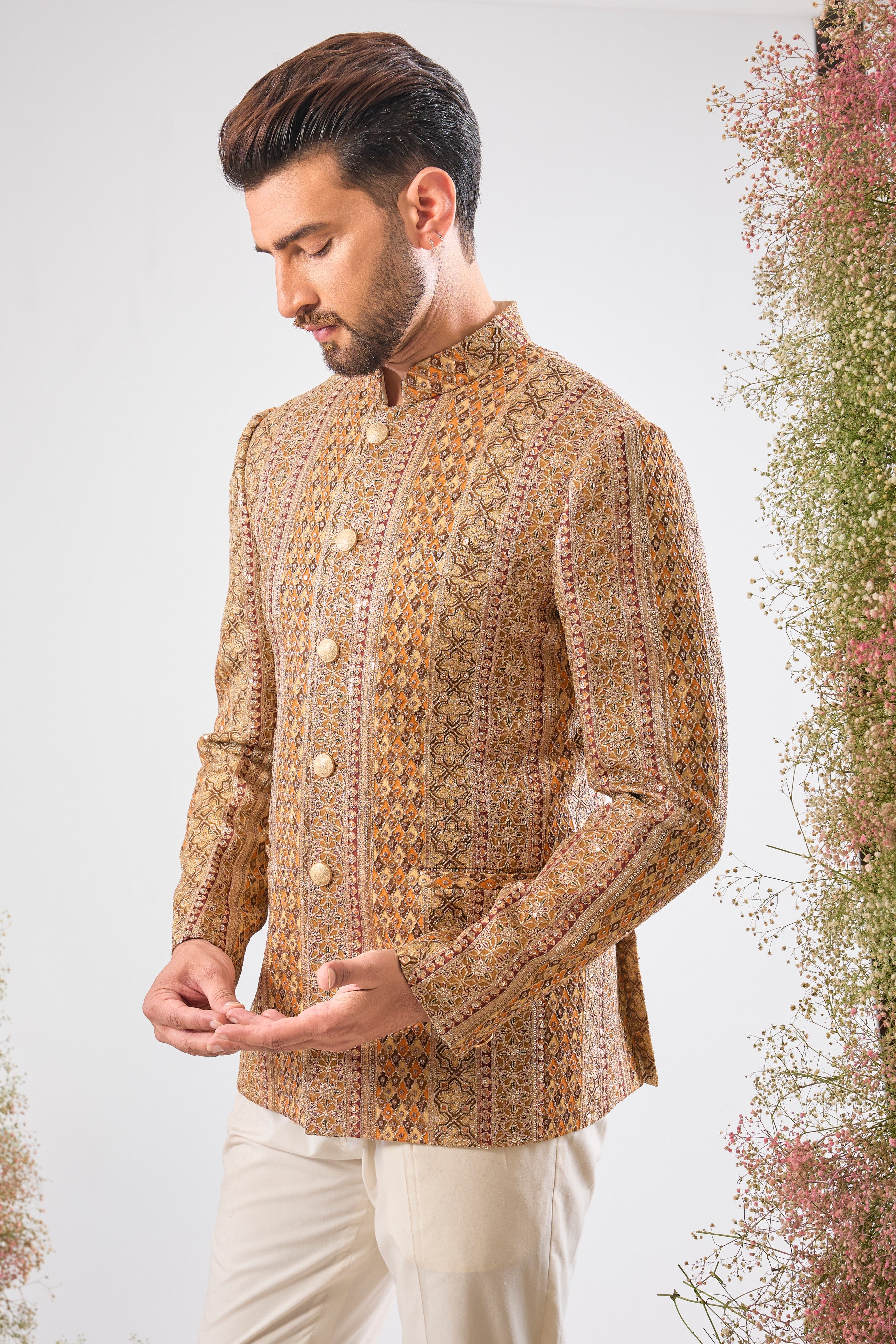 Artistry in vivid hues. This Mustard Bandhgala showcases opulent Heavy Zari Work and sequin accents, brilliantly integrating Shades of Green and Orange into the design.