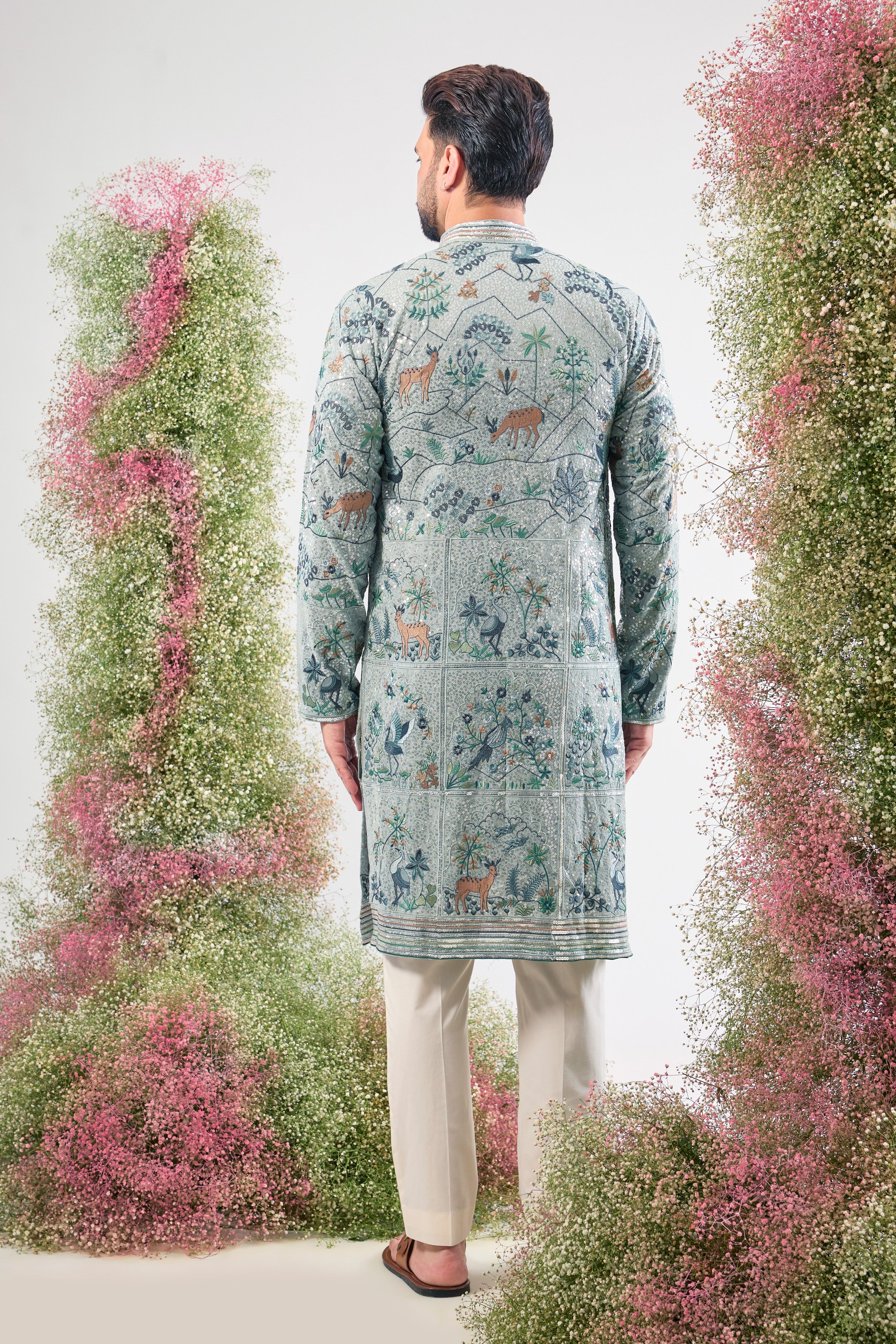 blue heavy sequined kurta with intricate flora and fauna embroidery