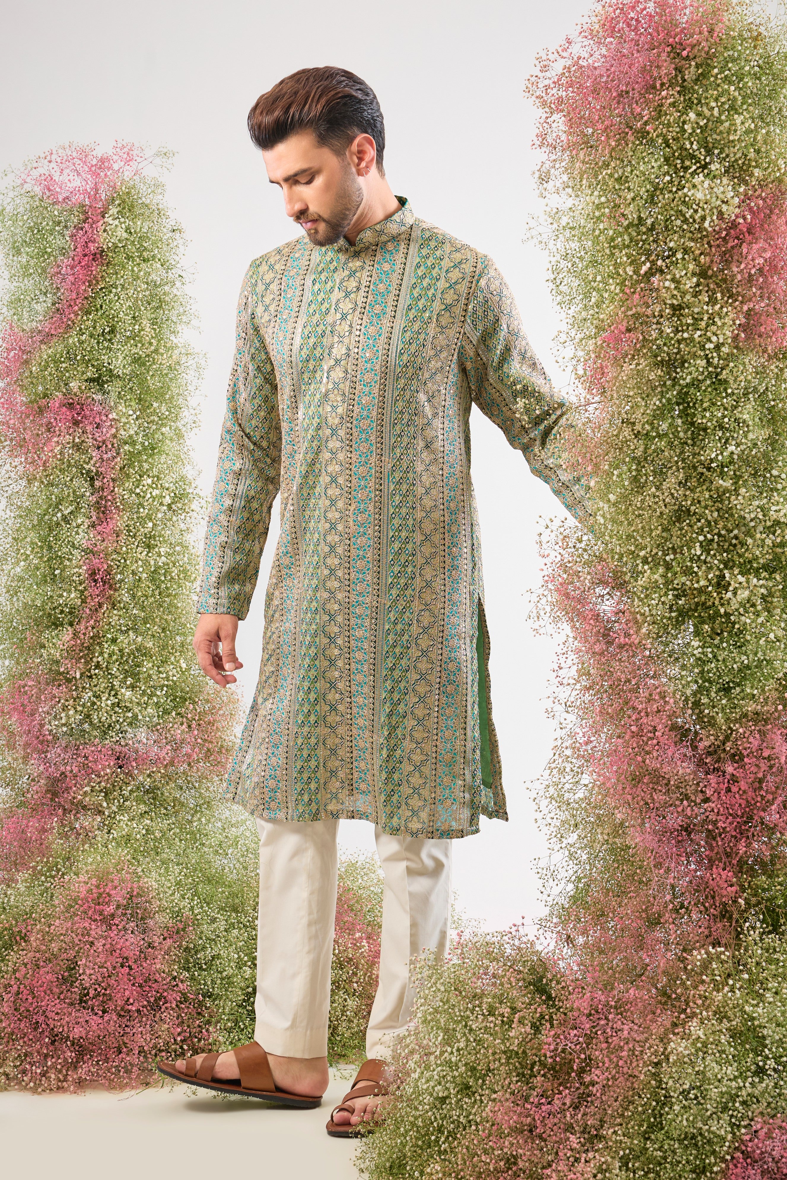 The vibrant Turquoise base of this kurta comes alive with Heavy Zari Work and the detailed sparkle of Intricate Sequin Embroidery.