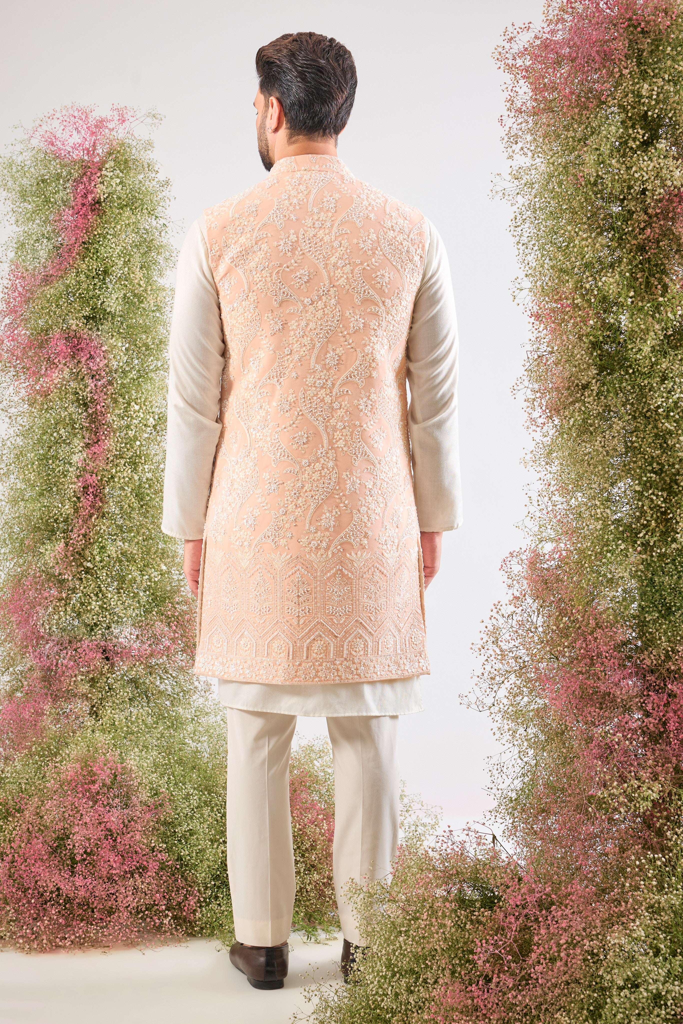 This stunning Pink Long Open Jacket is lavishly detailed with Intricate Hand Embroidered White Cut Dana work that catches the light beautifully.