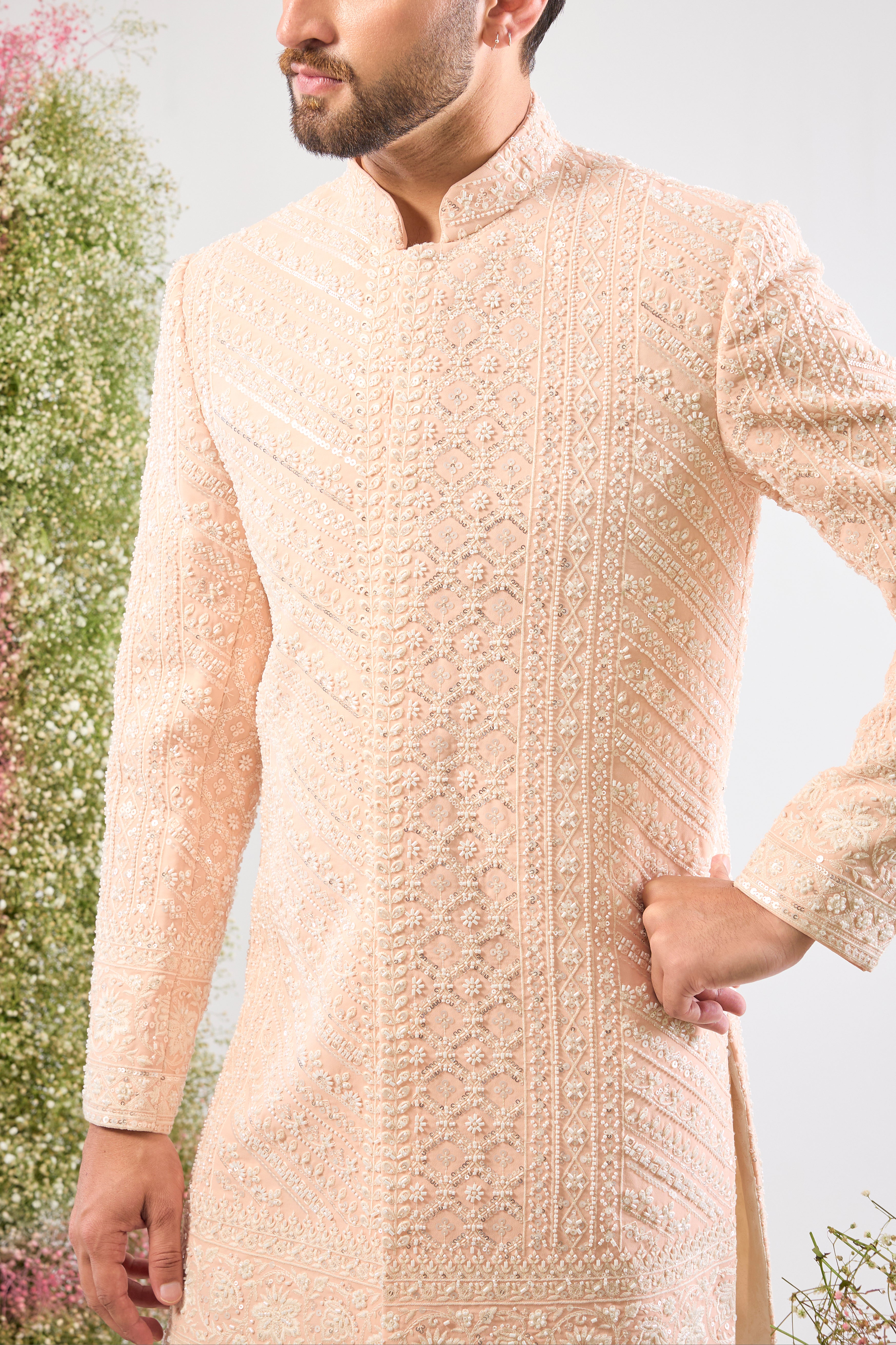 Introducing a truly One-of-a-Kind piece: our stunning Pink Short Sherwani. This is a Super Heavy Sherwani, adorned entirely with magnificent All Hand Work White Cut Dana and breathtakingly Detailed Sequin Work. ✨