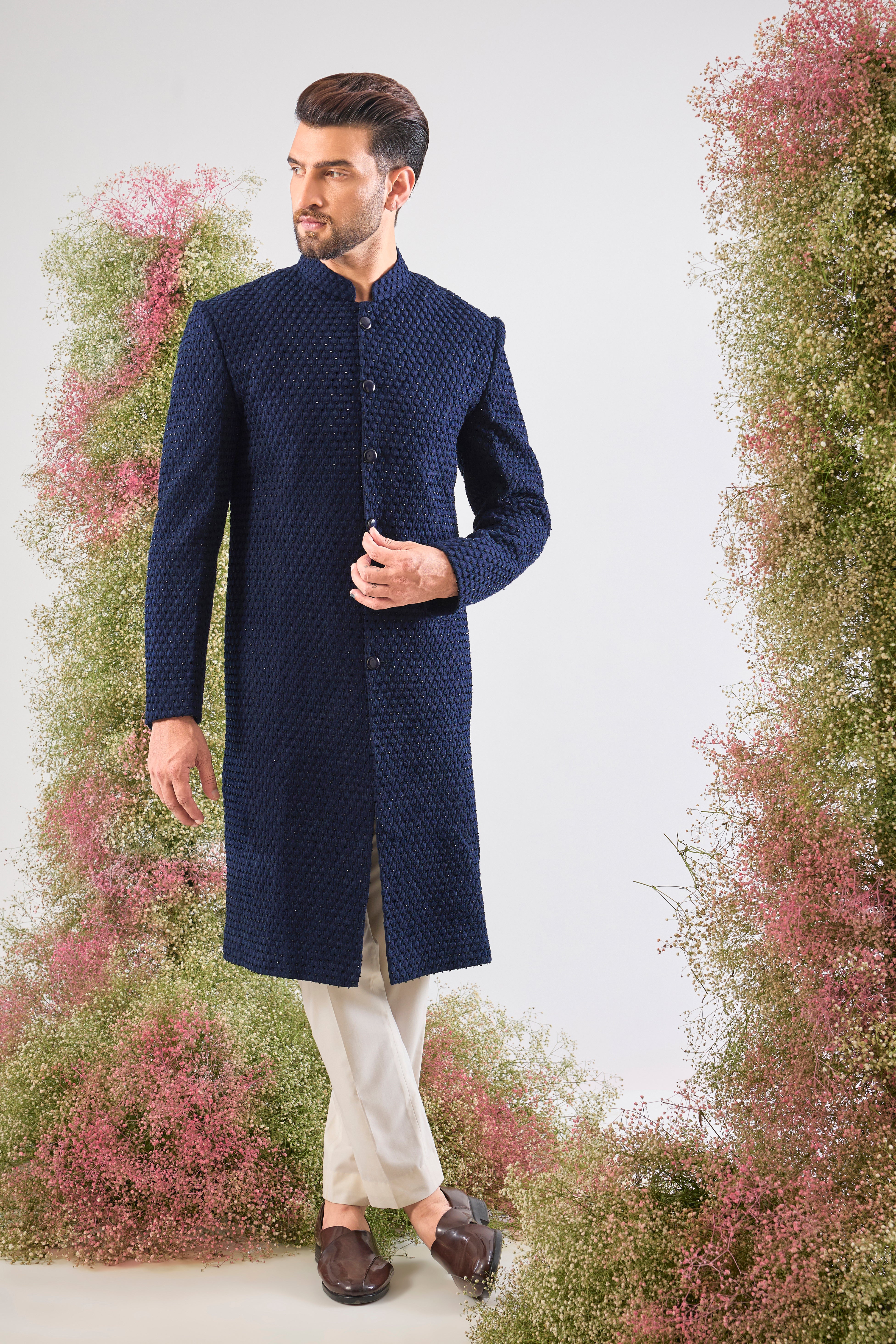 Navy Blue brilliance. This Sherwani features rich Tone-to-Tone Threadwork and sharp Black Cut Dana detailing. Subtly stunning. š