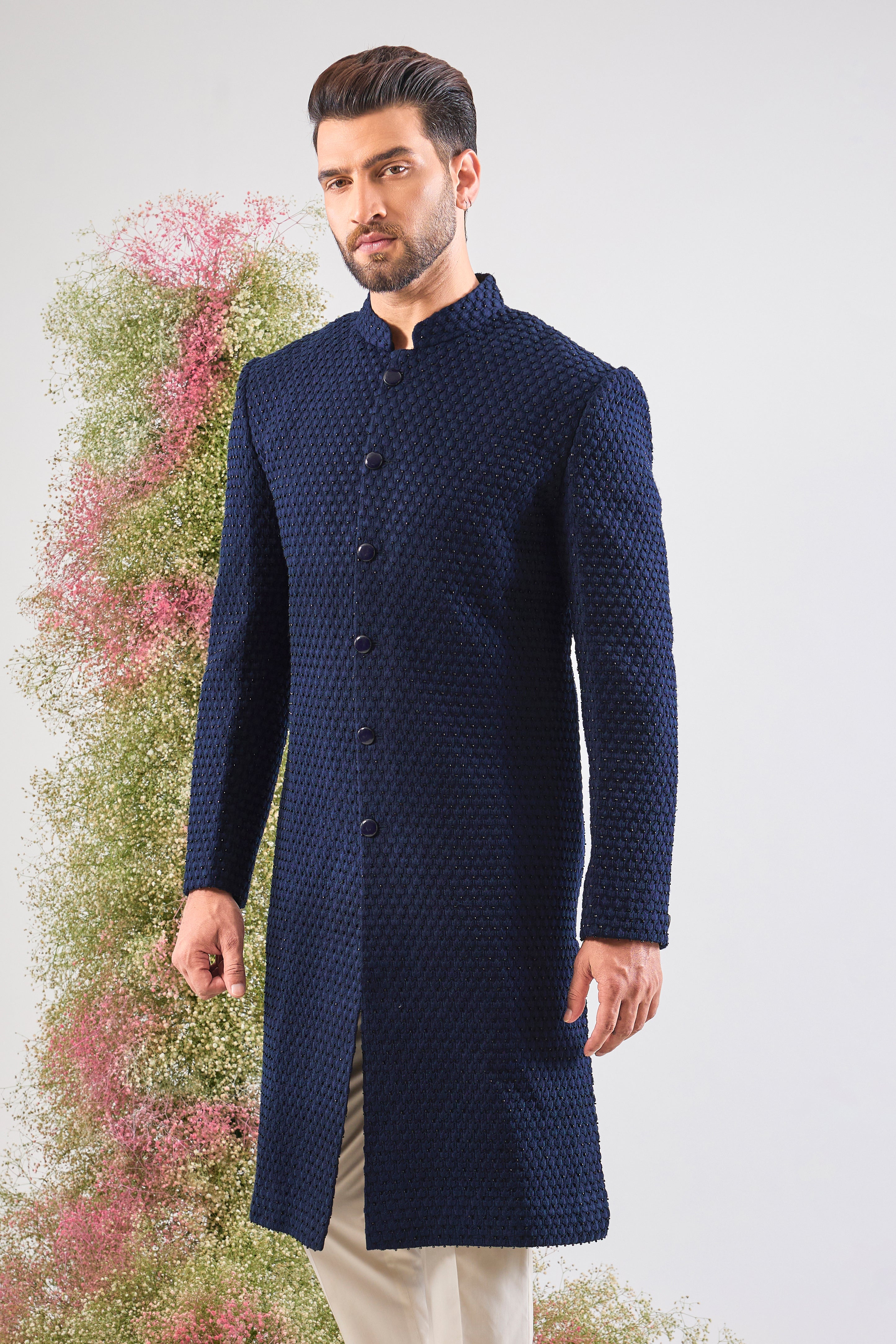 Navy Blue brilliance. This Sherwani features rich Tone-to-Tone Threadwork and sharp Black Cut Dana detailing. Subtly stunning. š