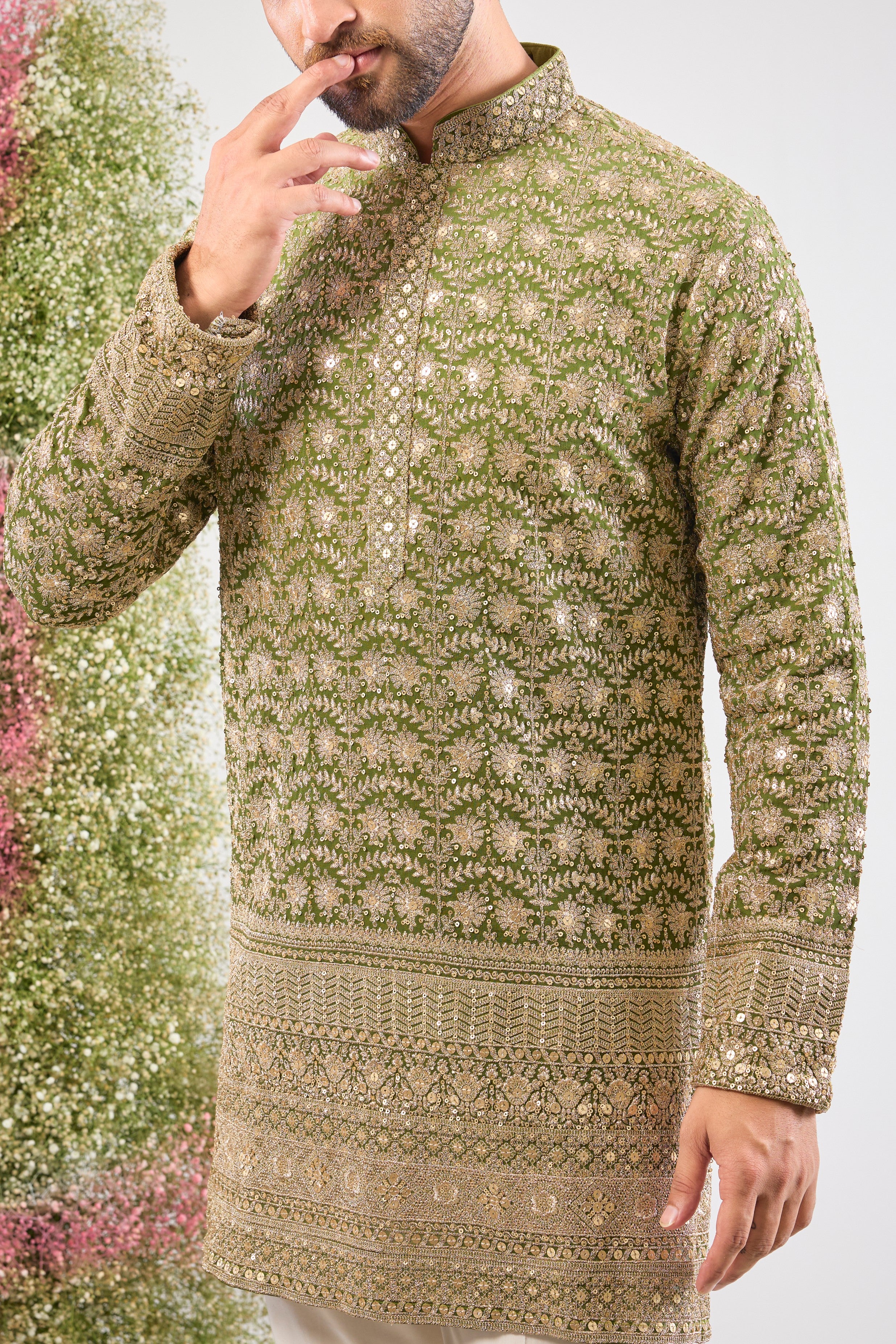 Our Green Ombre Shaded Kurta boasts a breathtaking silhouette, defined by its luxurious Heavy Zari Ghera (flare). The gradient green is richly covered in Heavy Zari Work and subtle Sequin Details, creating an aura of unparalleled festive elegance. ✨