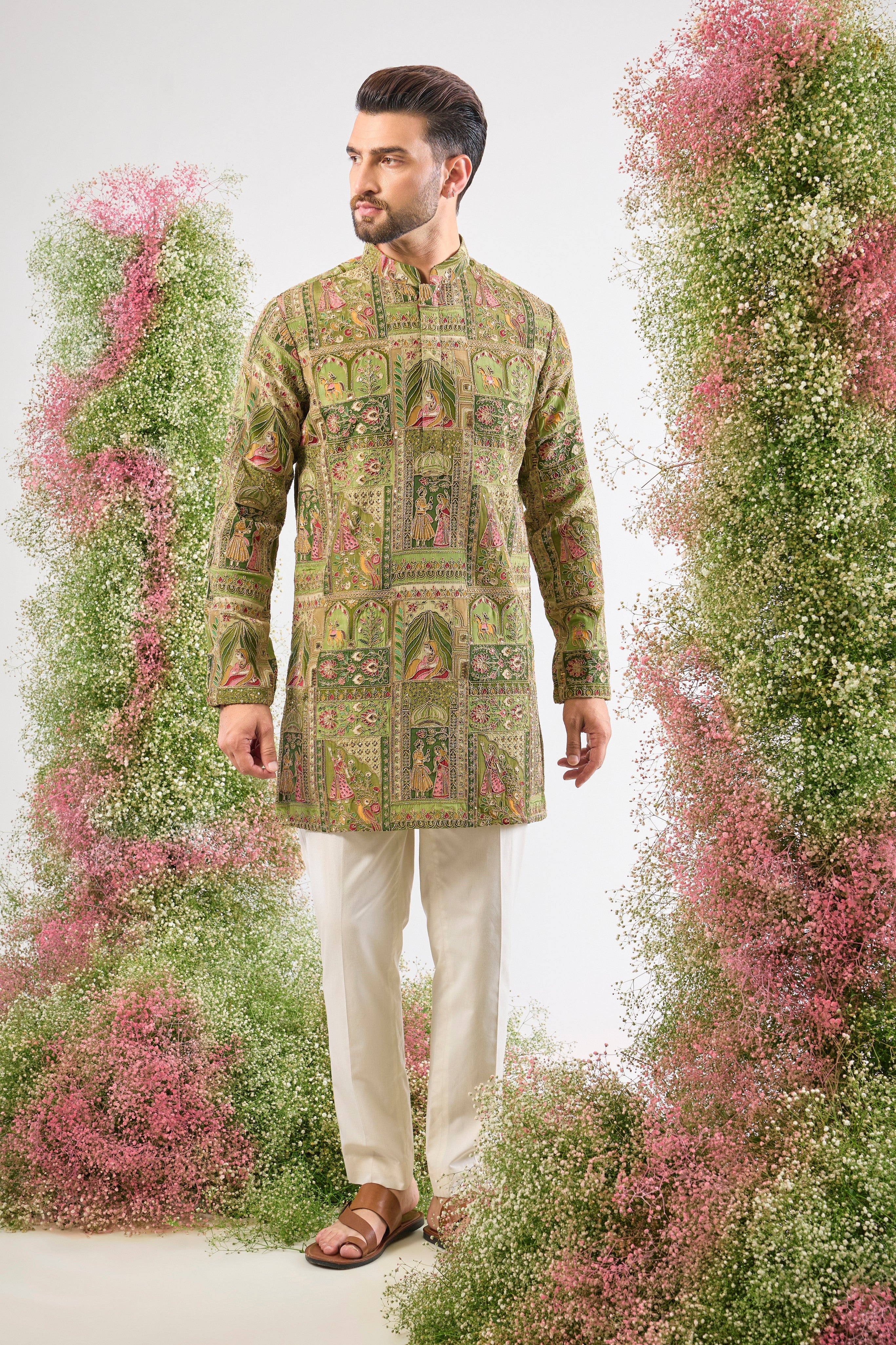 Green grandeur. Mughal history. Our Short Kurta is lavishly detailed with Heavy Zari Work and stunning Mughal Darbar Figures. A piece of wearable heritage