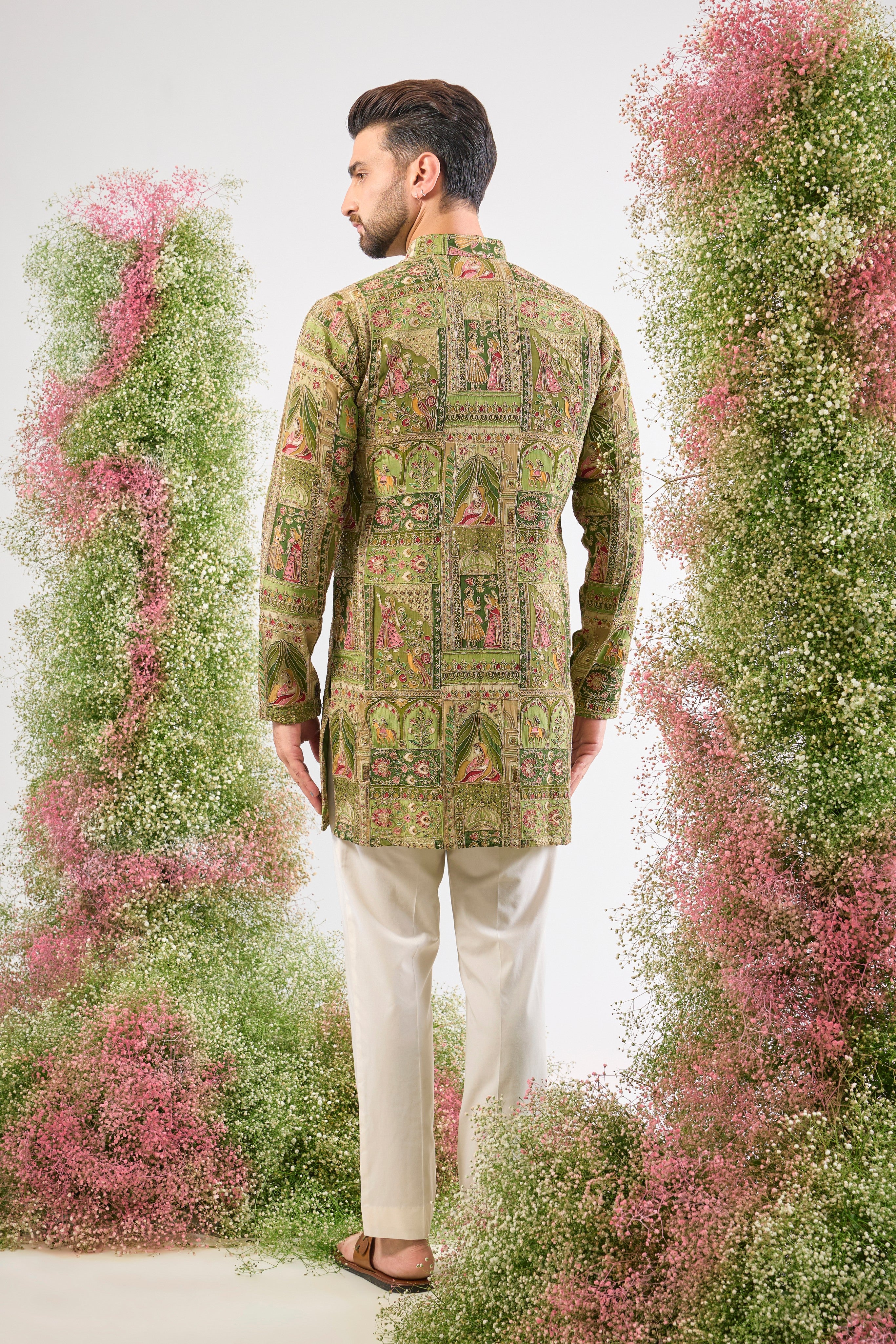 Green grandeur. Mughal history. Our Short Kurta is lavishly detailed with Heavy Zari Work and stunning Mughal Darbar Figures. A piece of wearable heritage