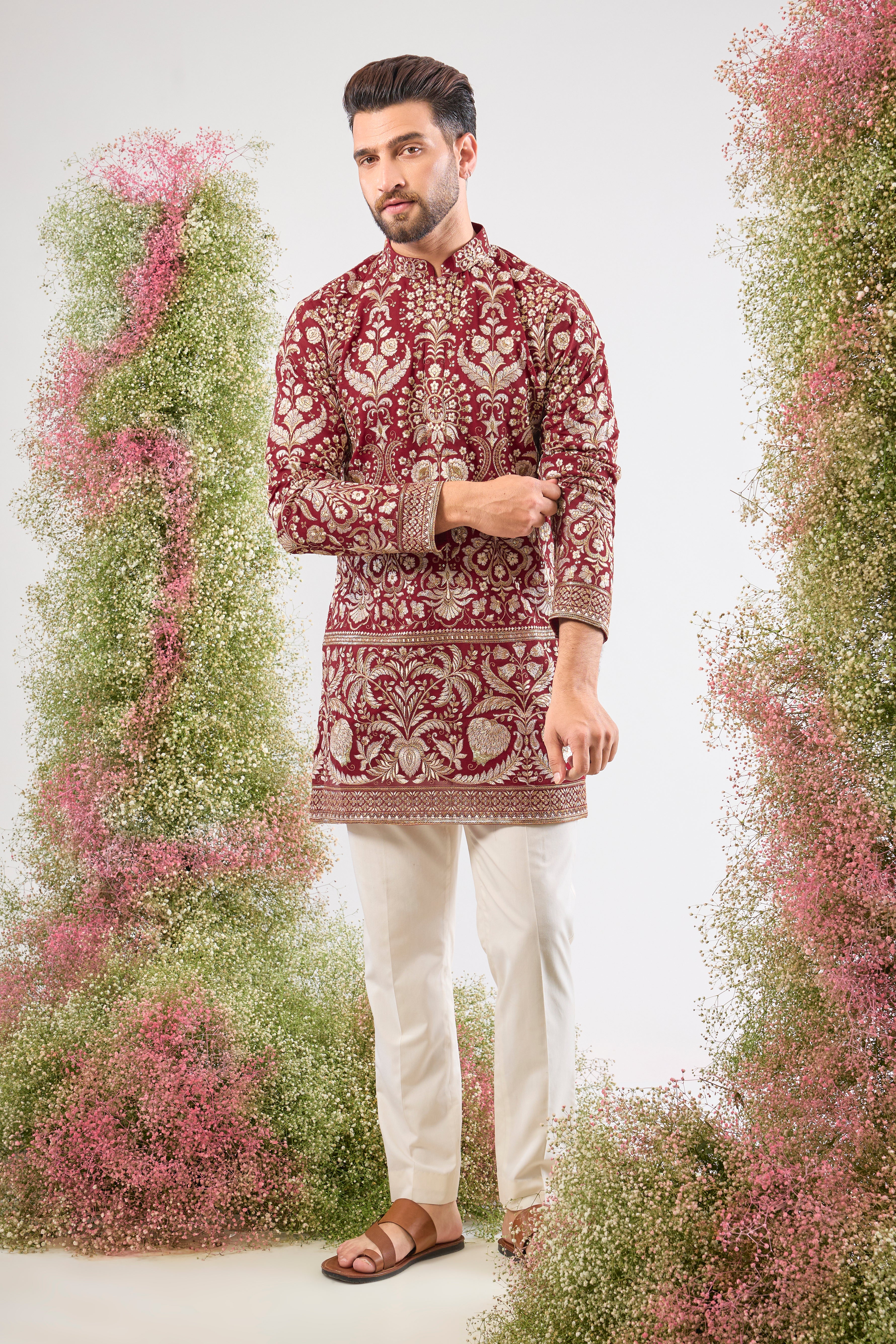 A regal masterpiece in maroon. This Short Kurta showcases magnificent Intricate Heavy Zari and sequin embellishment, achieving a breathtaking texture. The silhouette is perfected with a traditional Heavy Ghera, adding to its imperial feel.