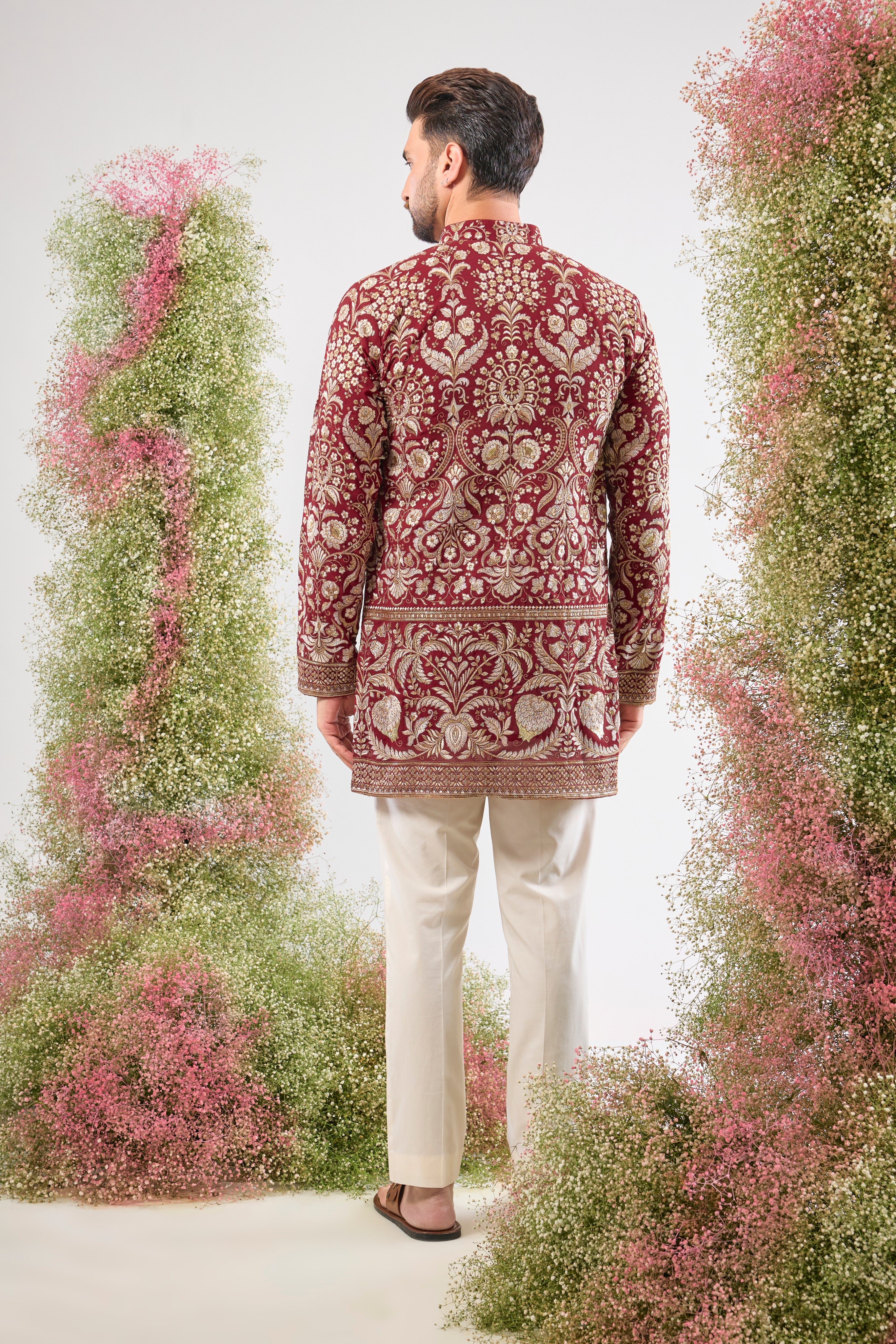 A regal masterpiece in maroon. This Short Kurta showcases magnificent Intricate Heavy Zari and sequin embellishment, achieving a breathtaking texture. The silhouette is perfected with a traditional Heavy Ghera, adding to its imperial feel.