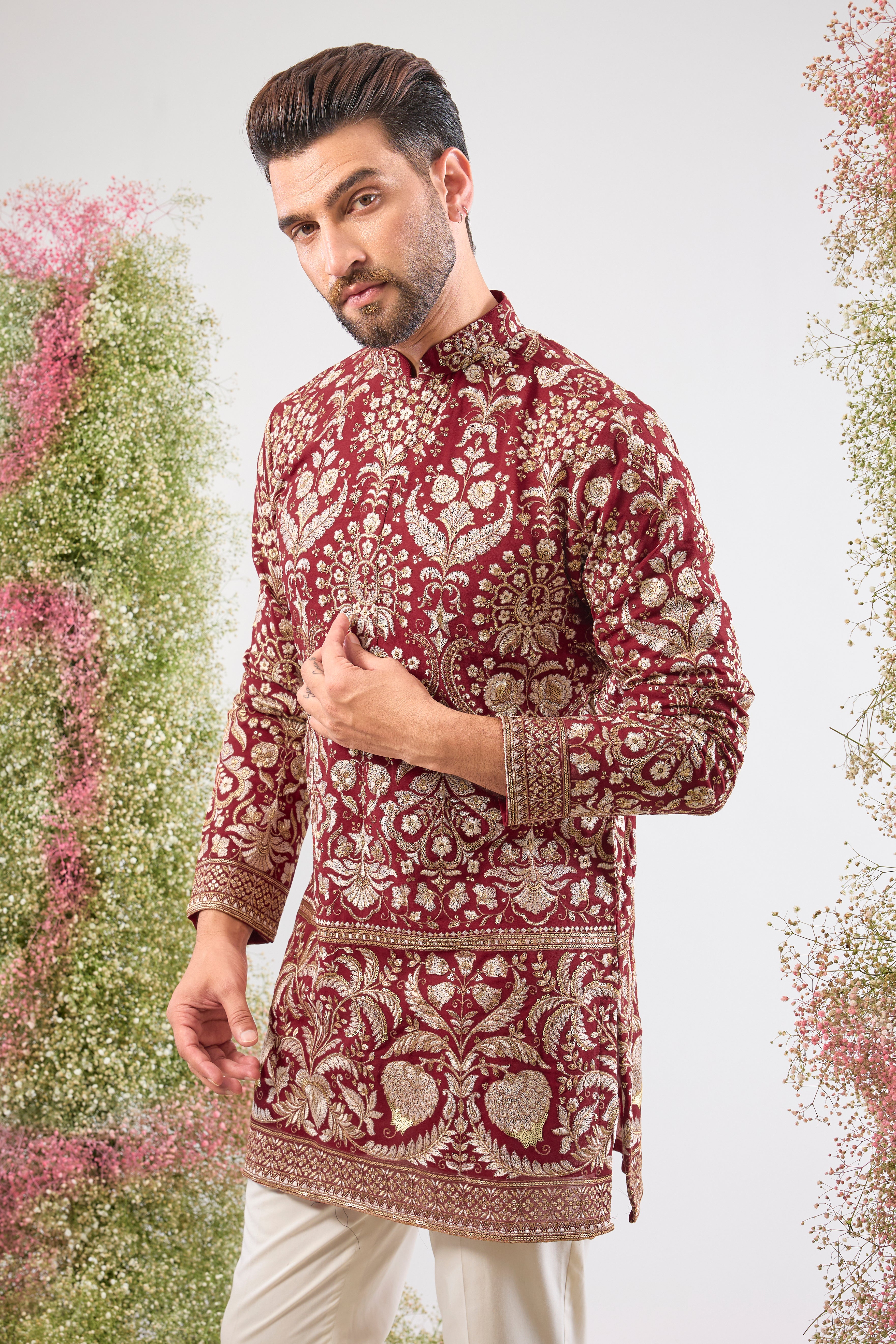 A regal masterpiece in maroon. This Short Kurta showcases magnificent Intricate Heavy Zari and sequin embellishment, achieving a breathtaking texture. The silhouette is perfected with a traditional Heavy Ghera, adding to its imperial feel.