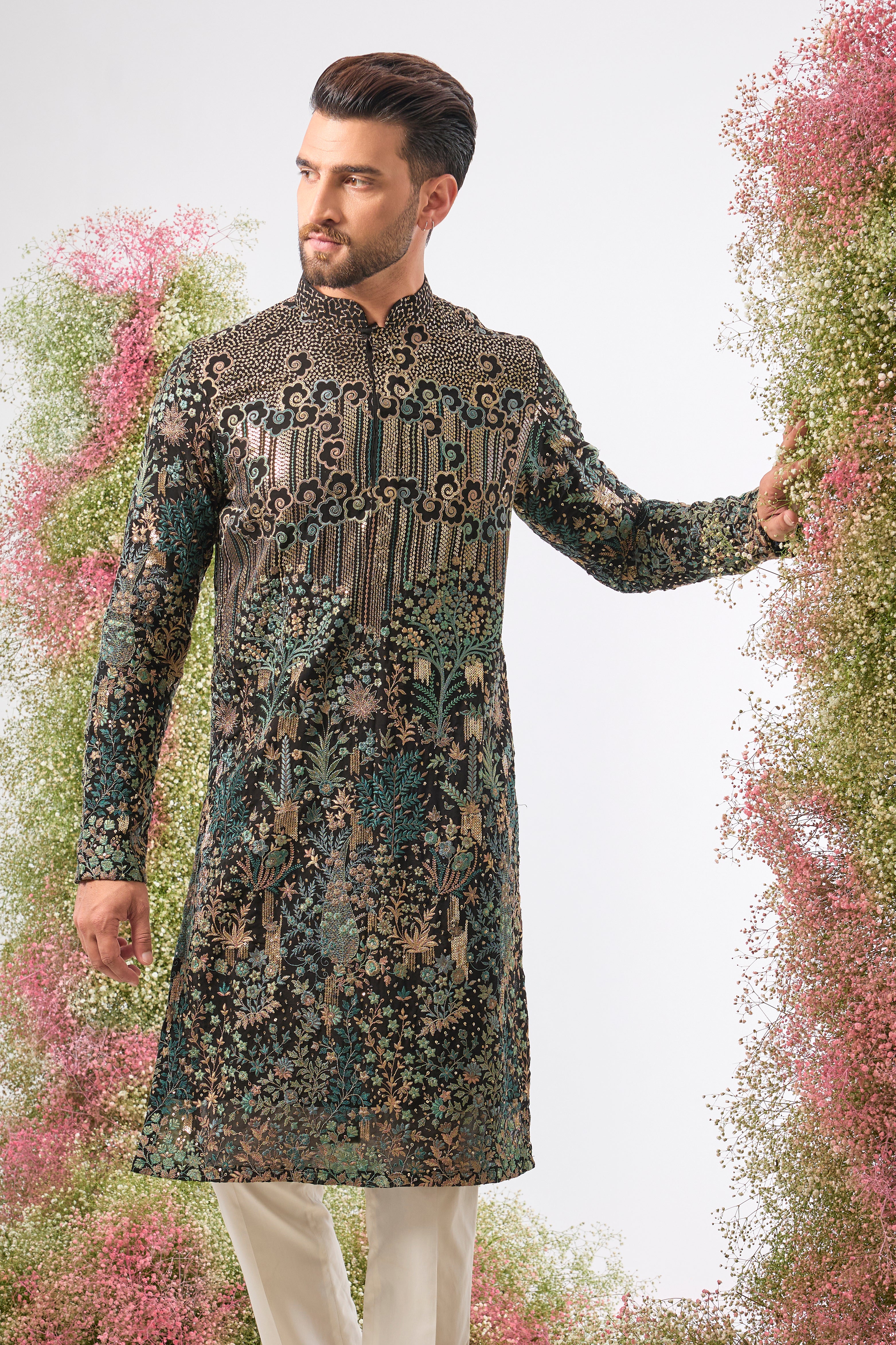 Wear a piece of dark art. This breathtaking Black Kurta features a Detailed Floral Tropical Era design, showcasing intricate artistry in Green and Black Threadwork.