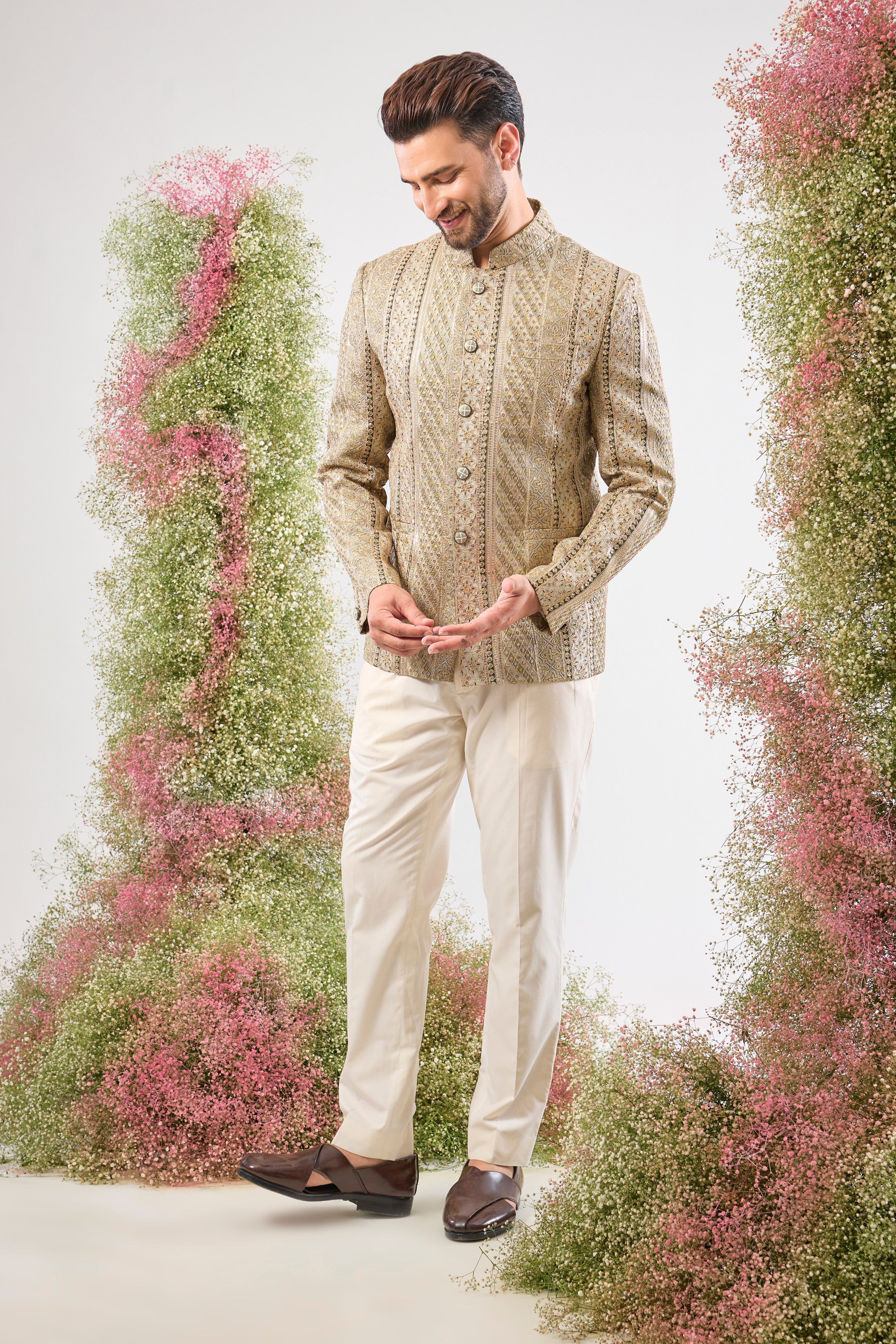 This Sage Green Bandhgala showcases rich Detailed Zari Work across the fabric, complemented by glittering sequin accents. The Classy Metal Buttons provide a sharp, polished finish to this exceptionally handsome jacket.