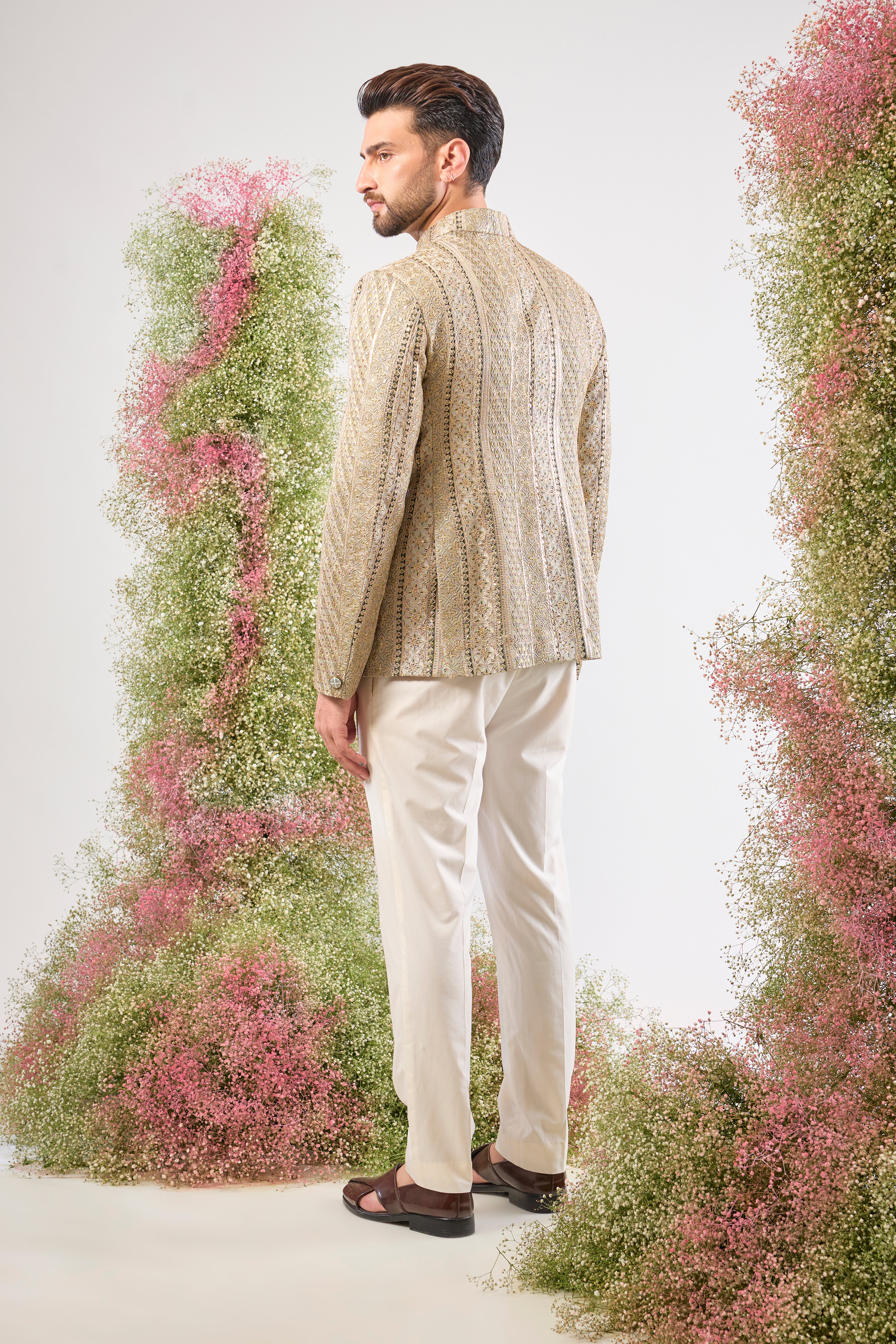 This Sage Green Bandhgala showcases rich Detailed Zari Work across the fabric, complemented by glittering sequin accents. The Classy Metal Buttons provide a sharp, polished finish to this exceptionally handsome jacket.