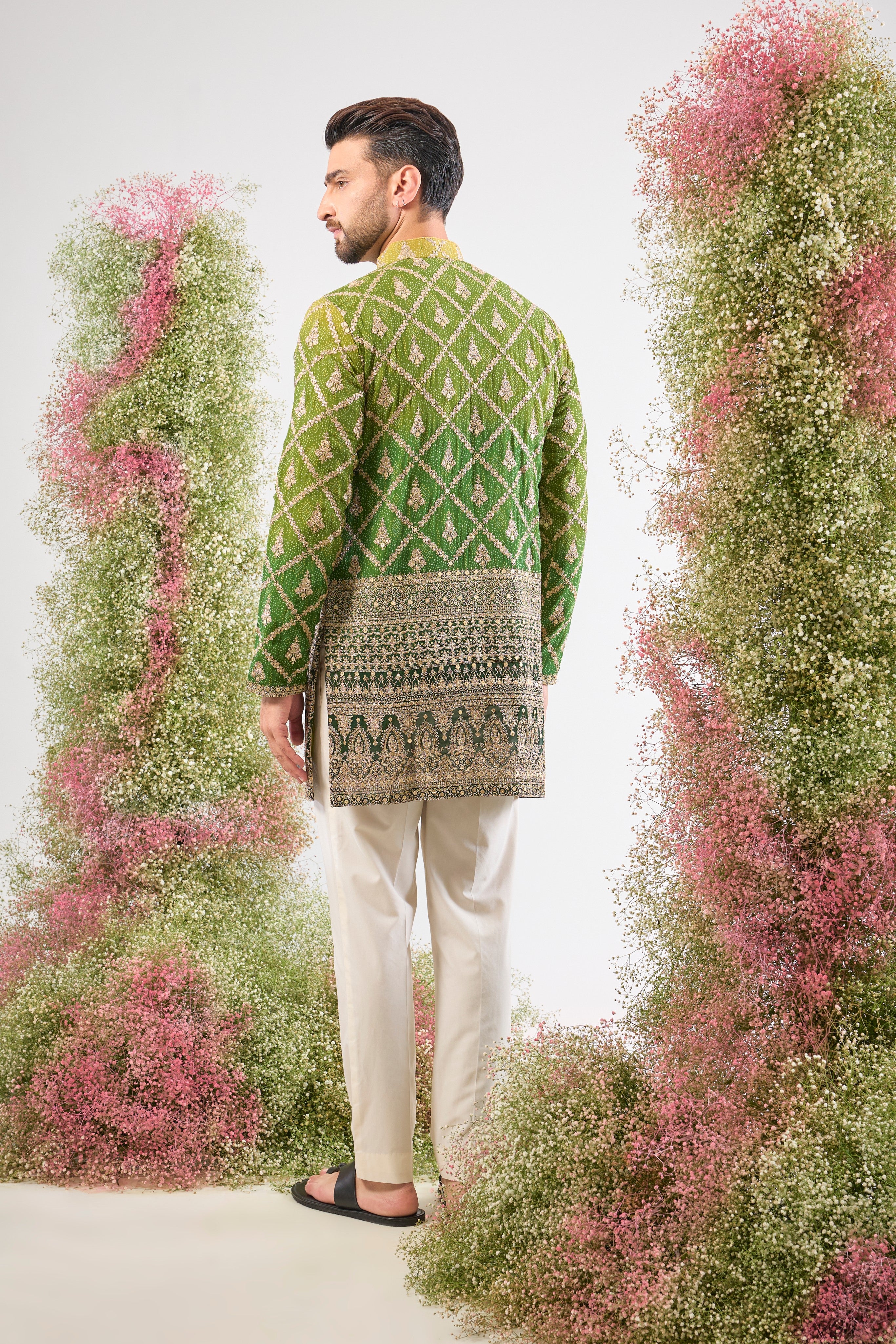 his Green Bandhani Print Short Kurta features an exceptionally rich Heavy Zari Work Border and sparkling sequin detailing. The contrast between the lively print and the dense embroidery is simply magnificent.