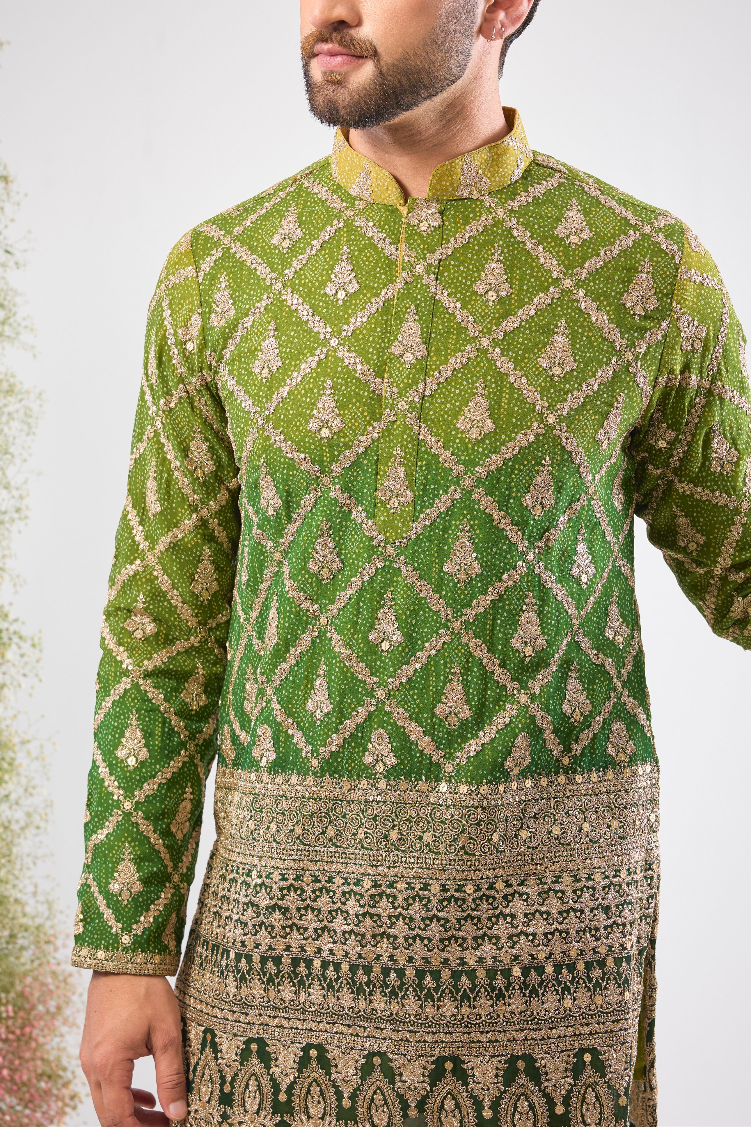 his Green Bandhani Print Short Kurta features an exceptionally rich Heavy Zari Work Border and sparkling sequin detailing. The contrast between the lively print and the dense embroidery is simply magnificent.