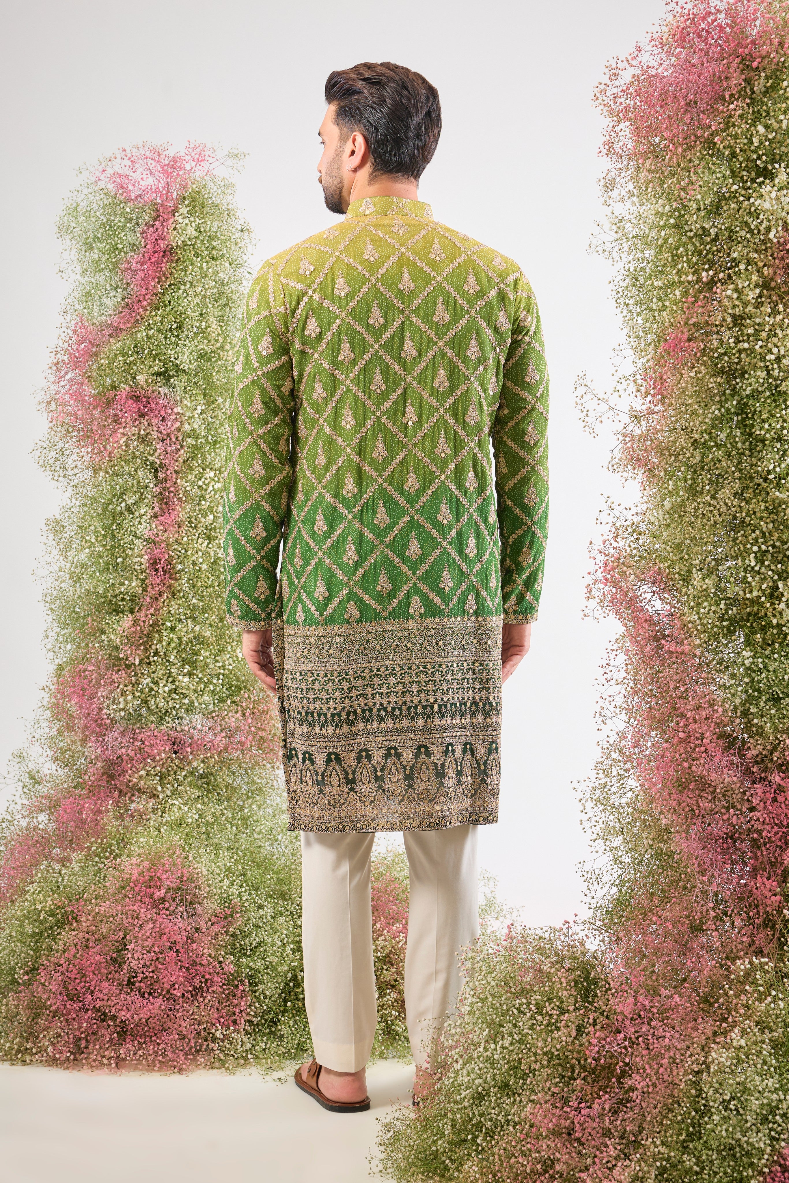 This Long Kurta in Bandhani Print features an exceptionally rich Heavy Zari Work Border and sparkling sequin detailing. The full length and dense embroidery create a truly majestic look.