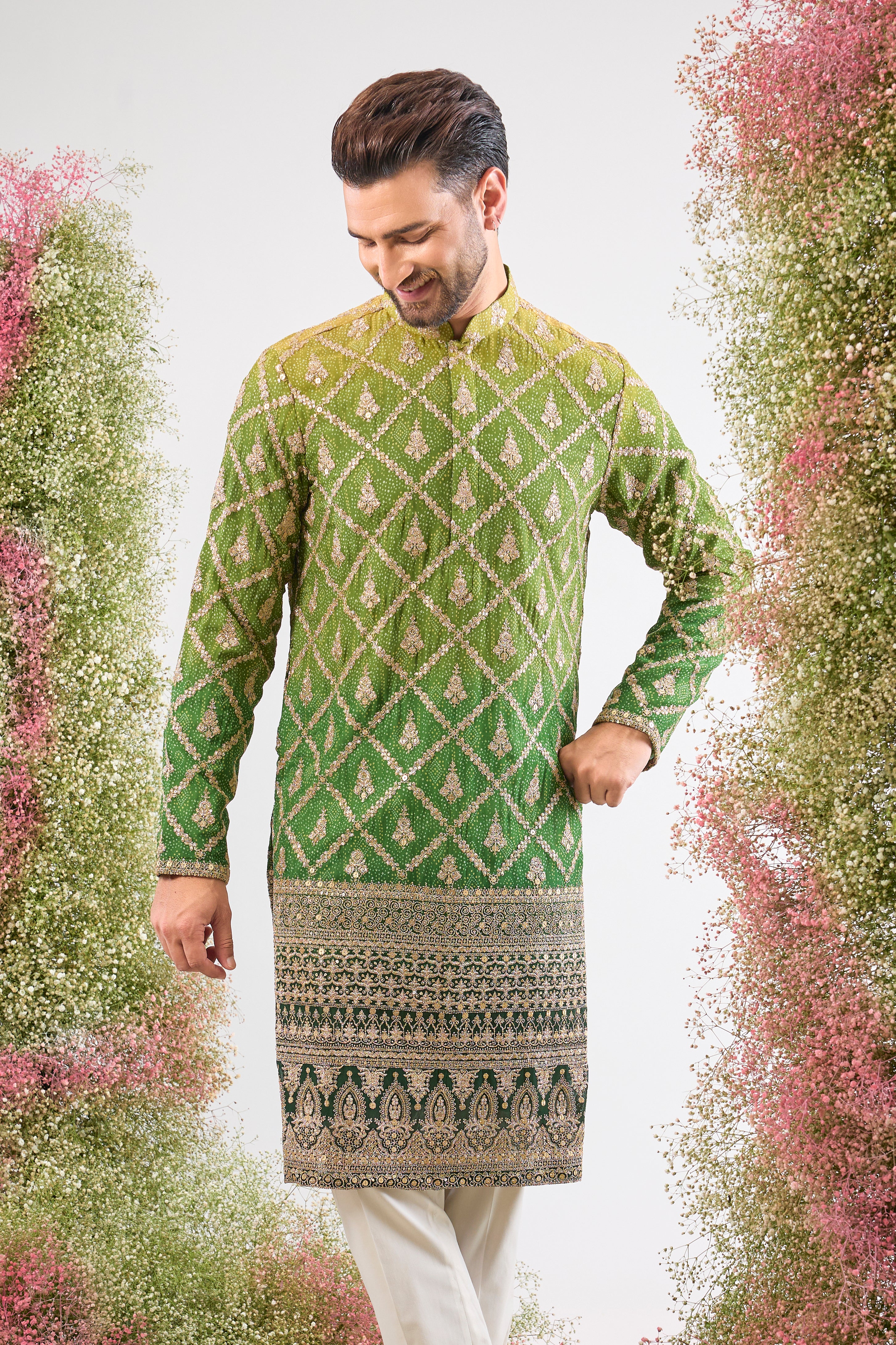 This Long Kurta in Bandhani Print features an exceptionally rich Heavy Zari Work Border and sparkling sequin detailing. The full length and dense embroidery create a truly majestic look.