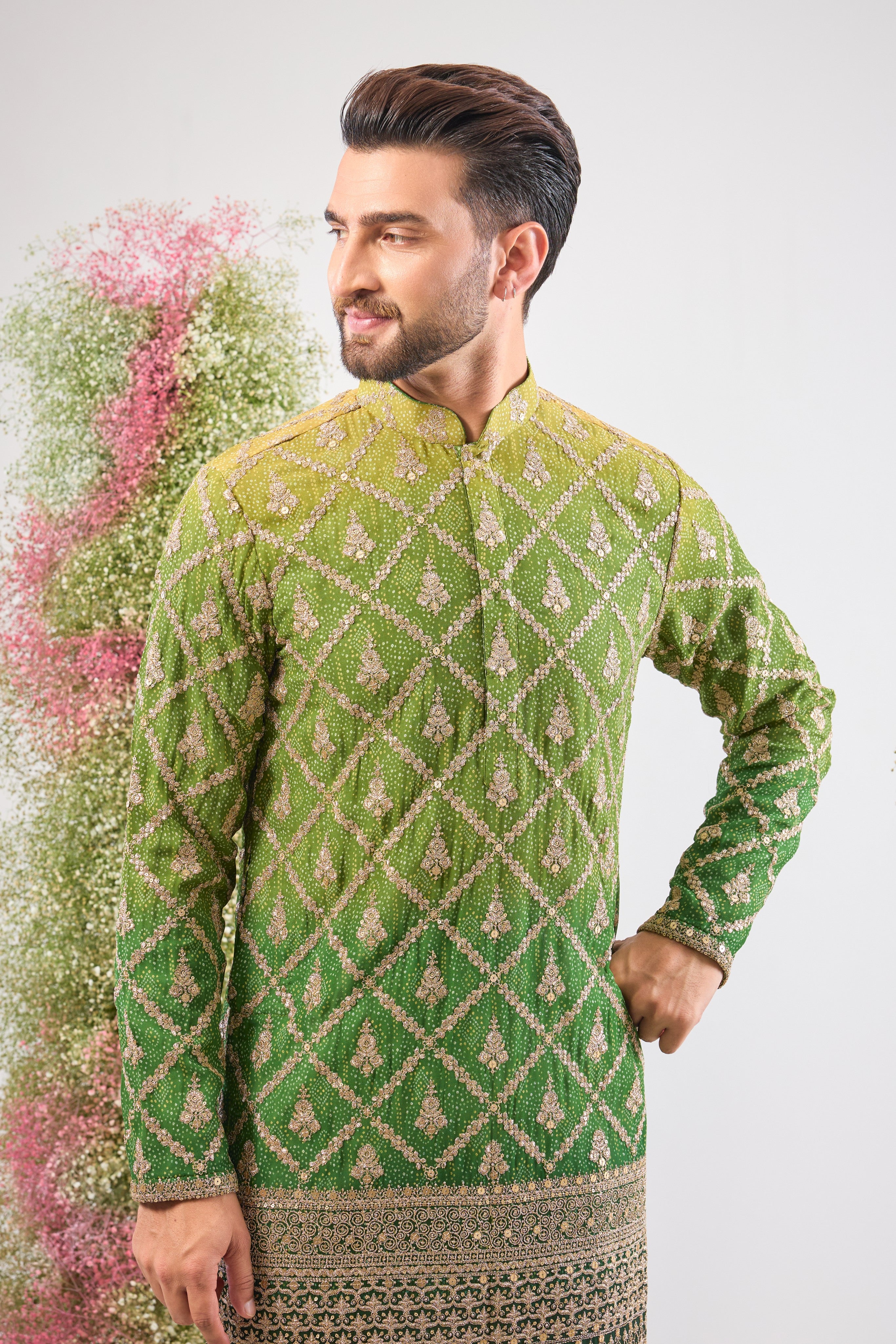 This Long Kurta in Bandhani Print features an exceptionally rich Heavy Zari Work Border and sparkling sequin detailing. The full length and dense embroidery create a truly majestic look.