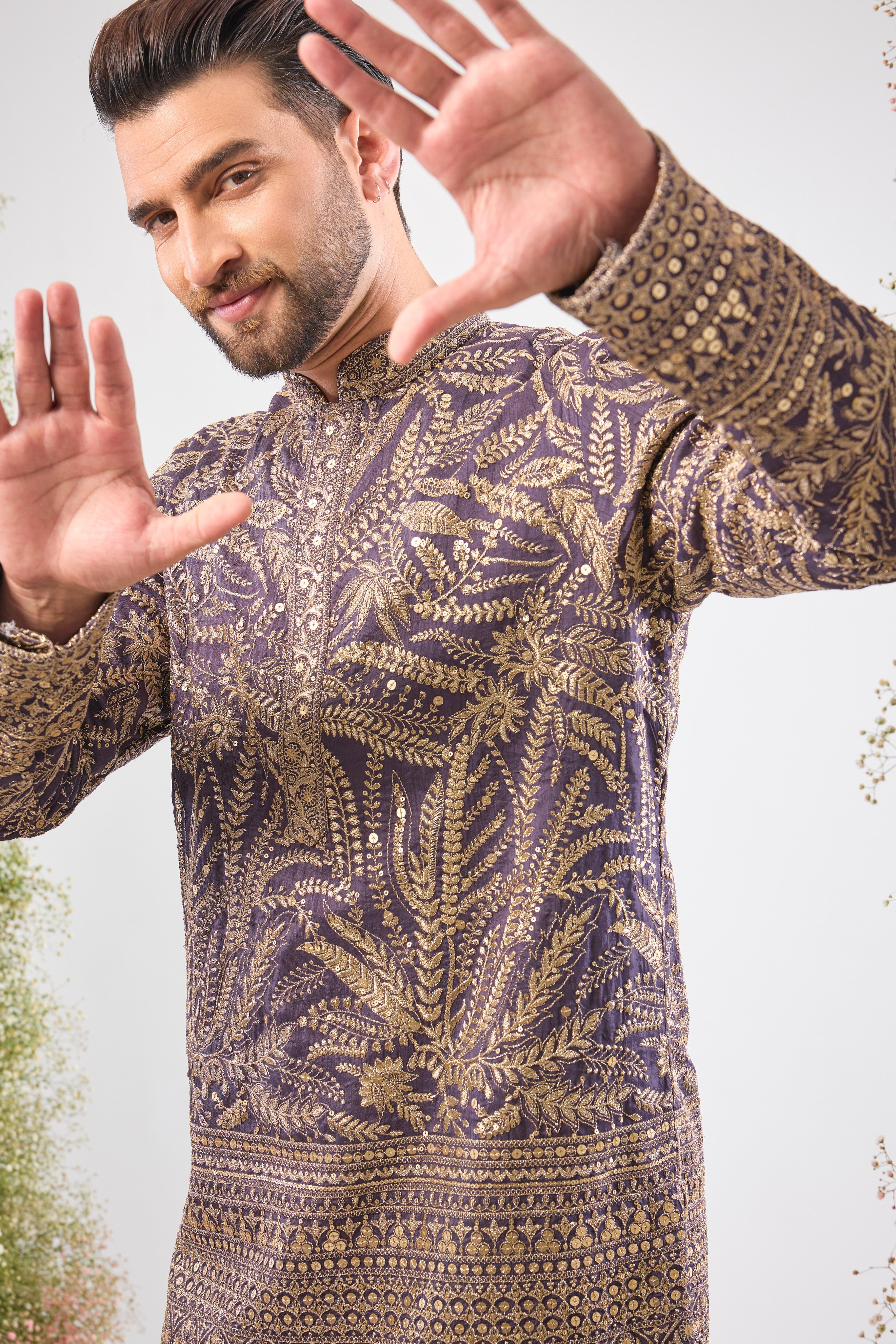 his Purple Mauve Short Zari Kurta is adorned with exquisite Detailed Floral Embroidery and shimmering sequins, creating incredible texture. The classic heavy ghera adds a majestic flow to the short silhouette.