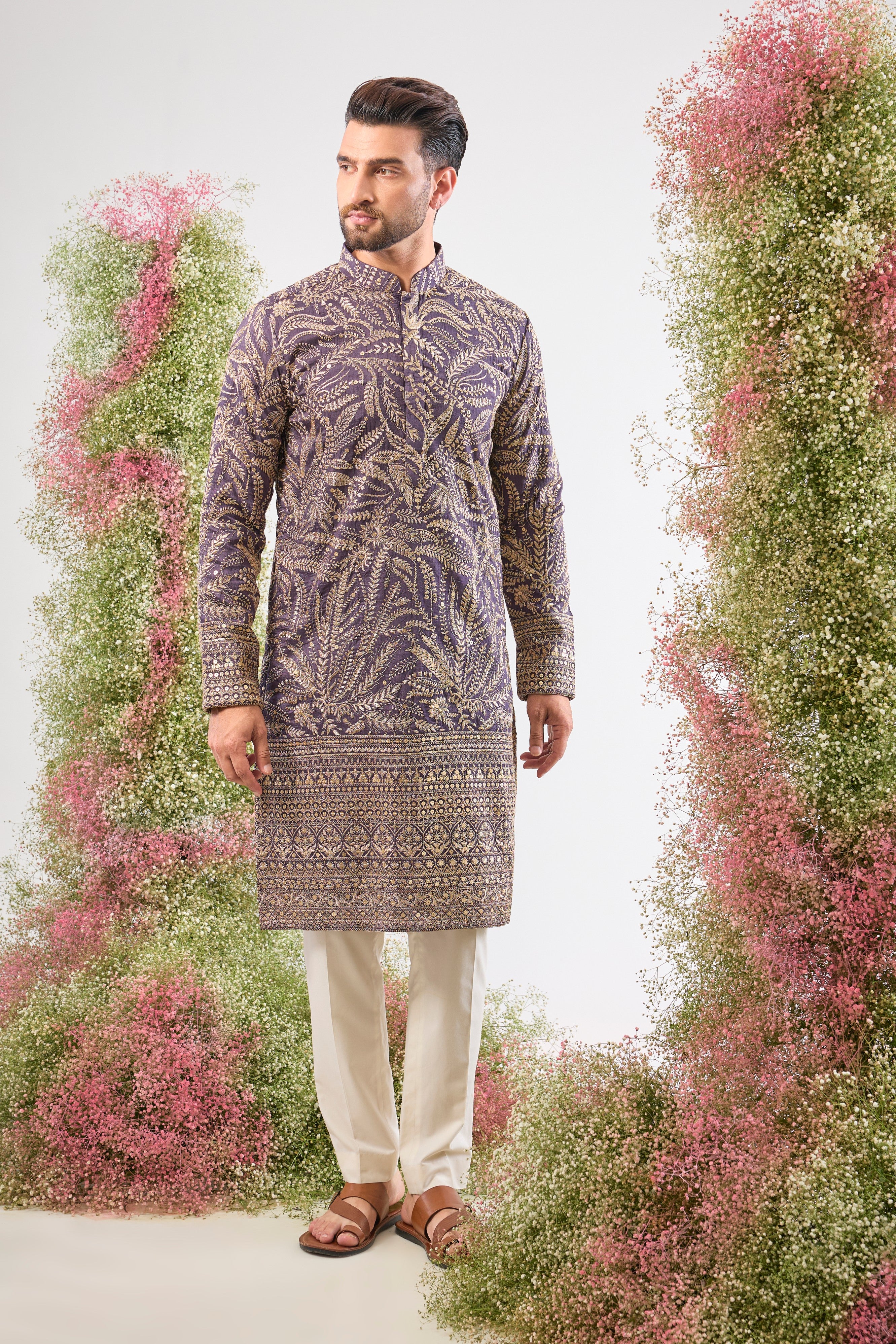 This Purple Mauve Long Zari Kurta is adorned with exquisite Detailed Floral Embroidery and shimmering sequins, creating incredible texture. The Heavy Ghera adds a dramatic, flowing elegance to the long silhouette.