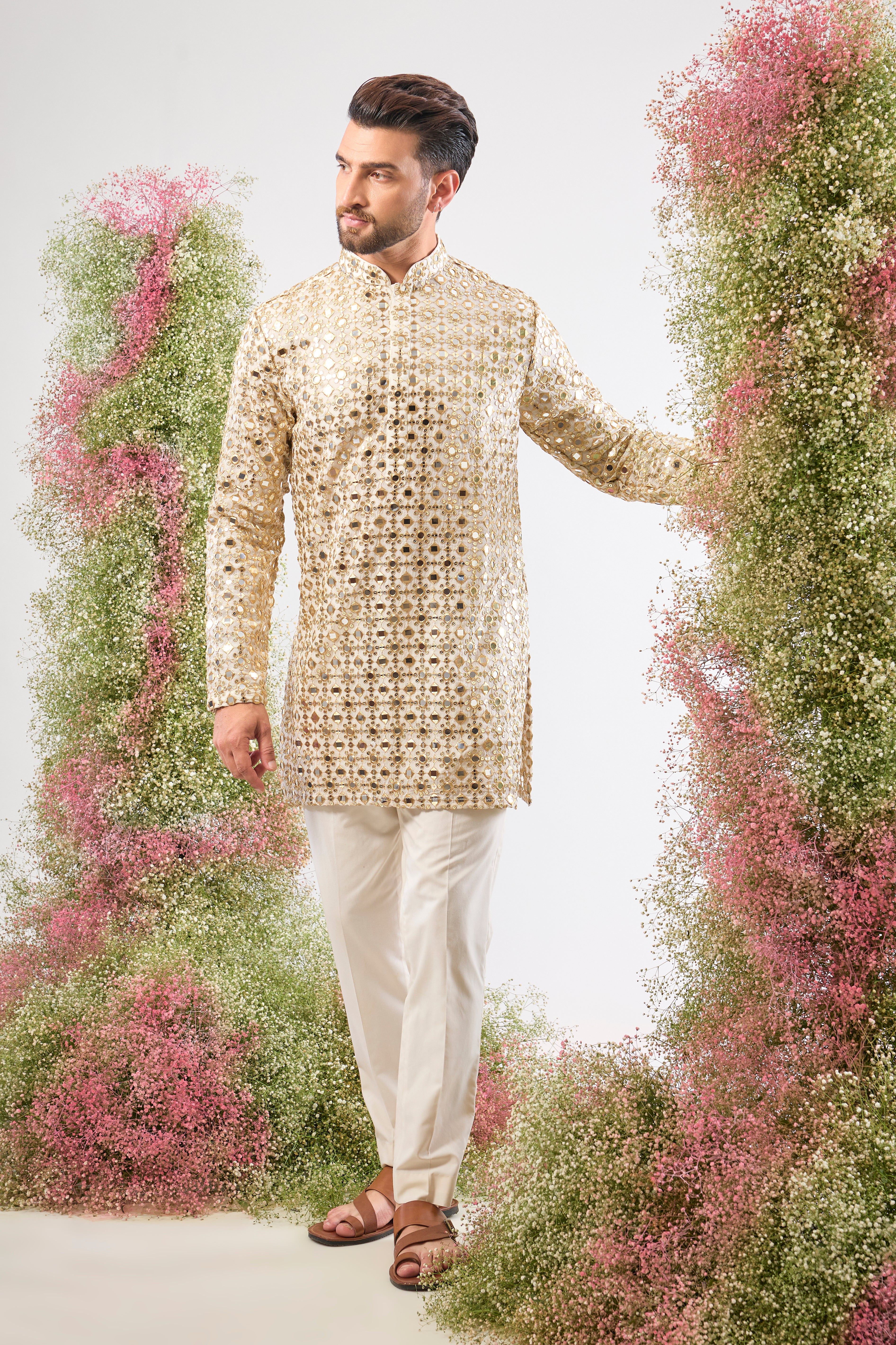 This White Short Mirror Work Kurta showcases the richness of Heavy Zari Work, providing unmatched texture and depth. The intensive sequin detailing guarantees a luminous, show-stopping look.