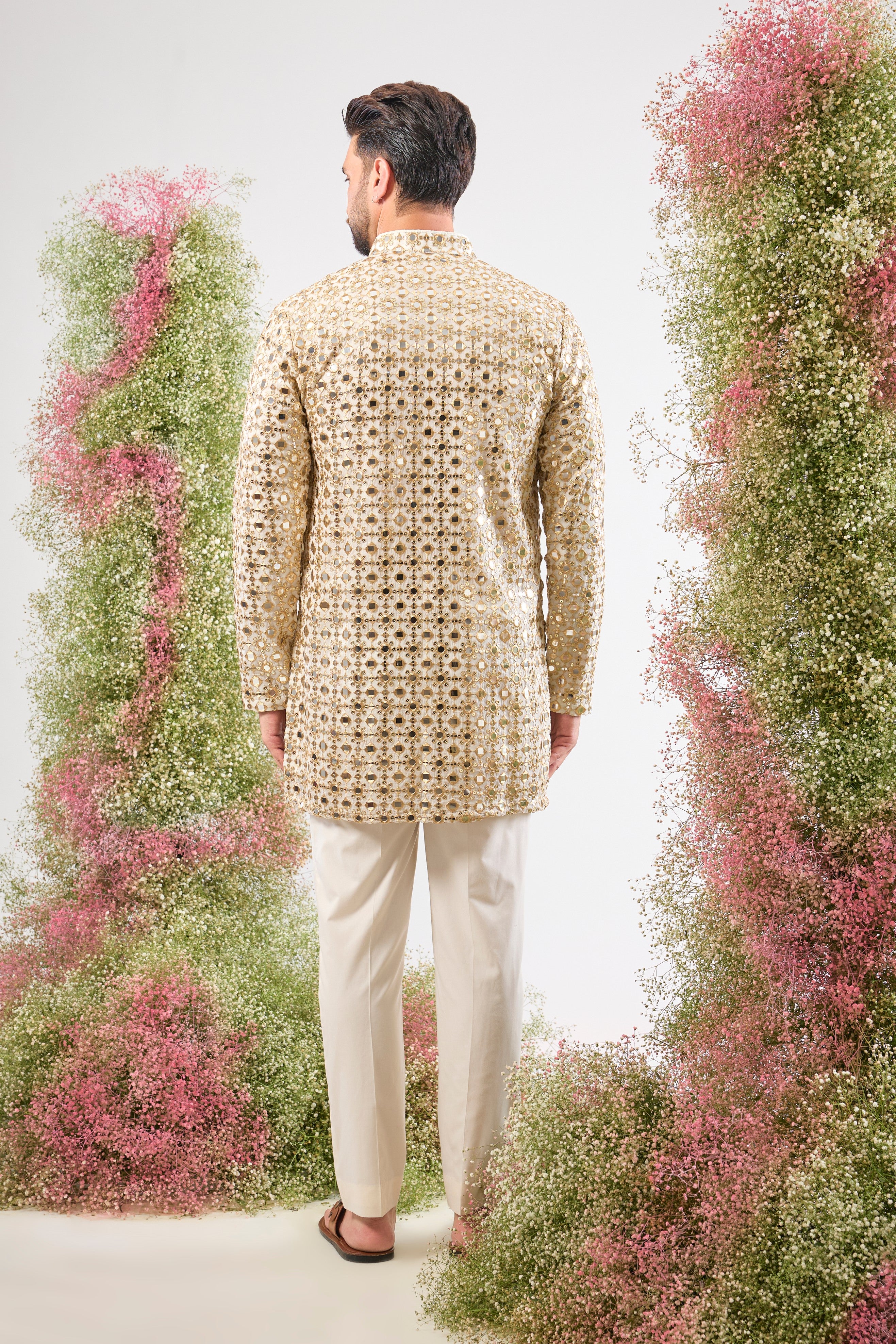 This White Short Mirror Work Kurta showcases the richness of Heavy Zari Work, providing unmatched texture and depth. The intensive sequin detailing guarantees a luminous, show-stopping look.